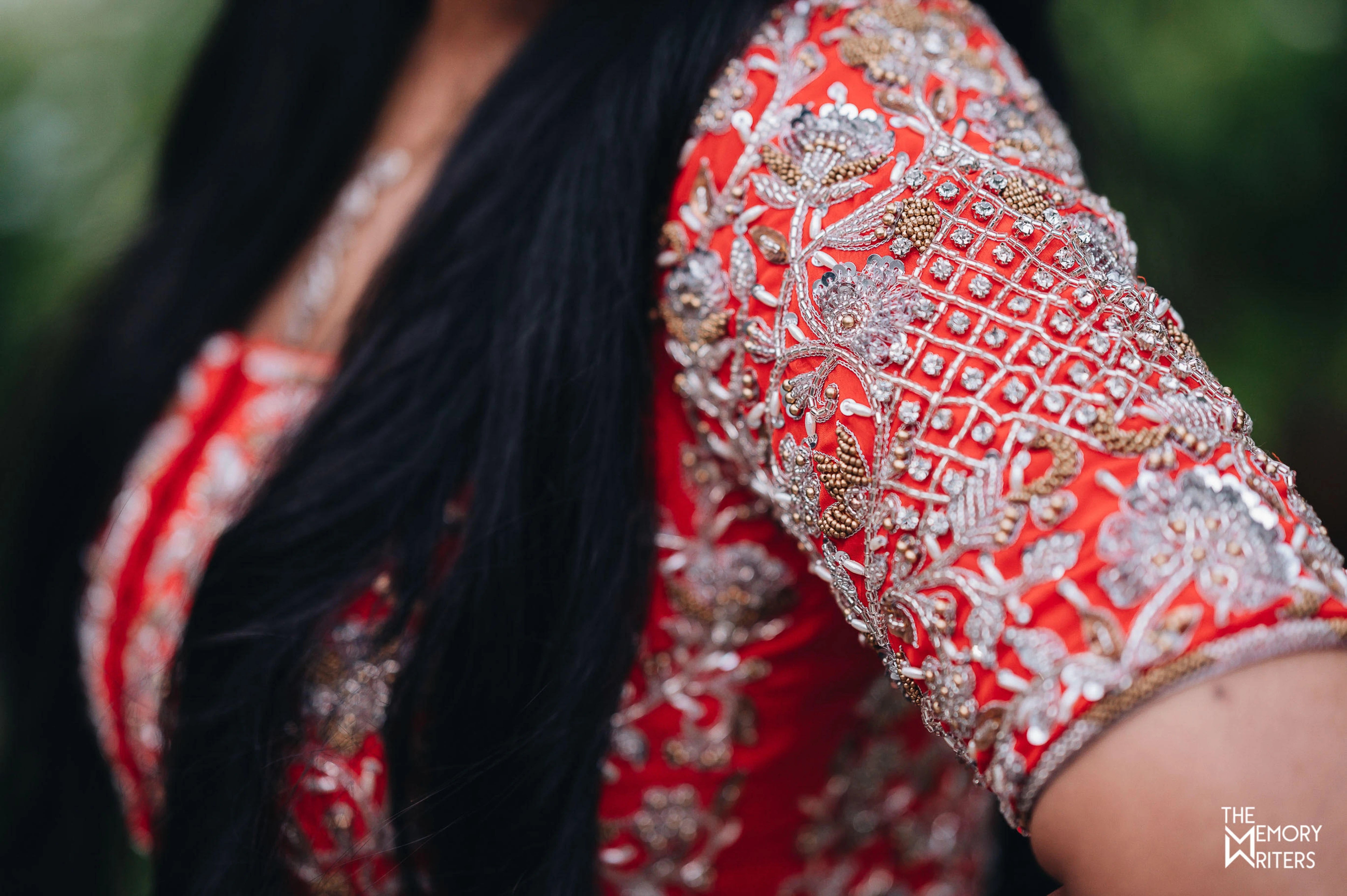 Bride from Erode in a handcrafted orange masakali lehenga with cut dana, sequins and beads in tulle showcasing the detailing the front of the yoke.