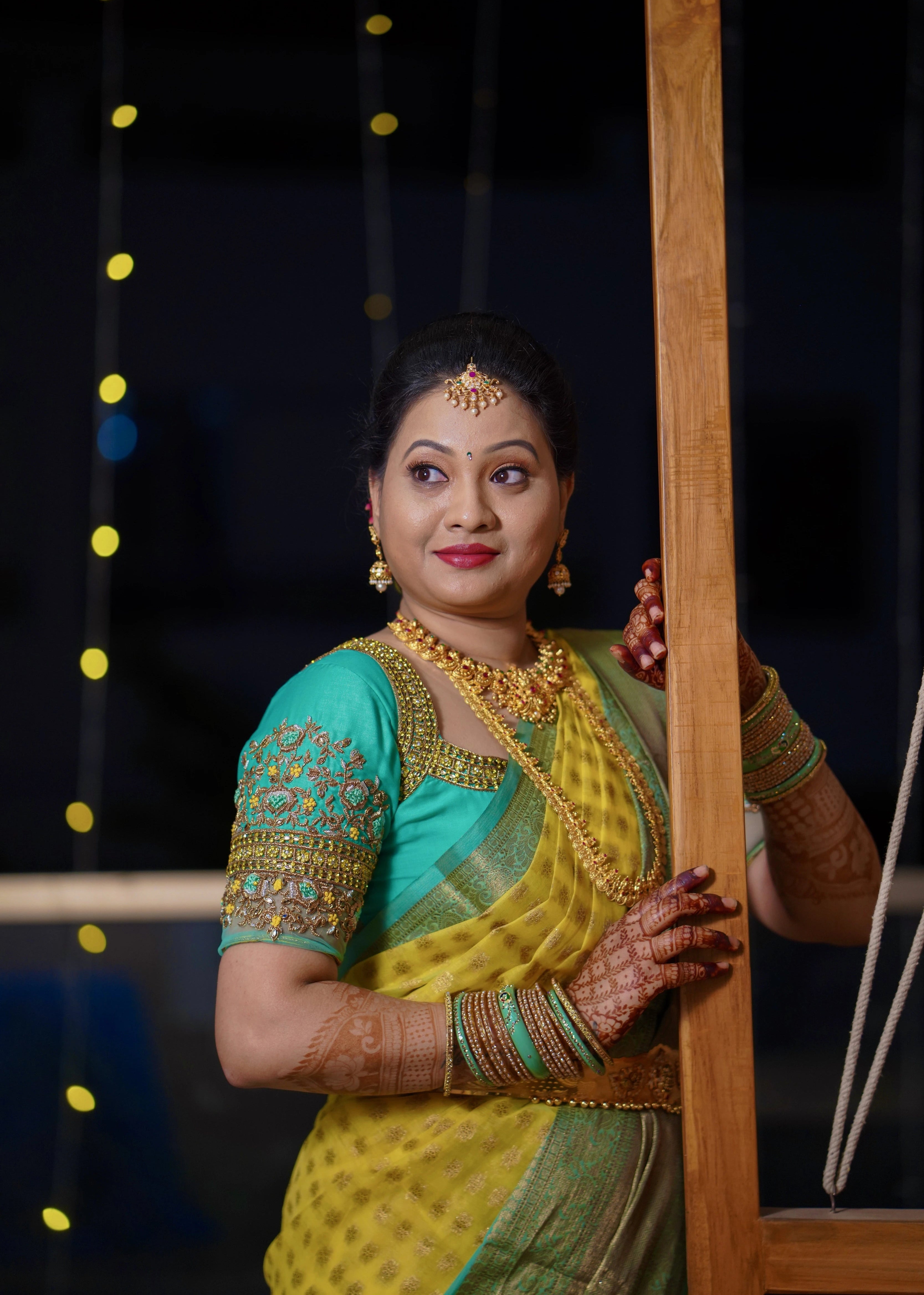 Bride from Seattle looking away in an aquamarine blouse designed by Archana Karthick