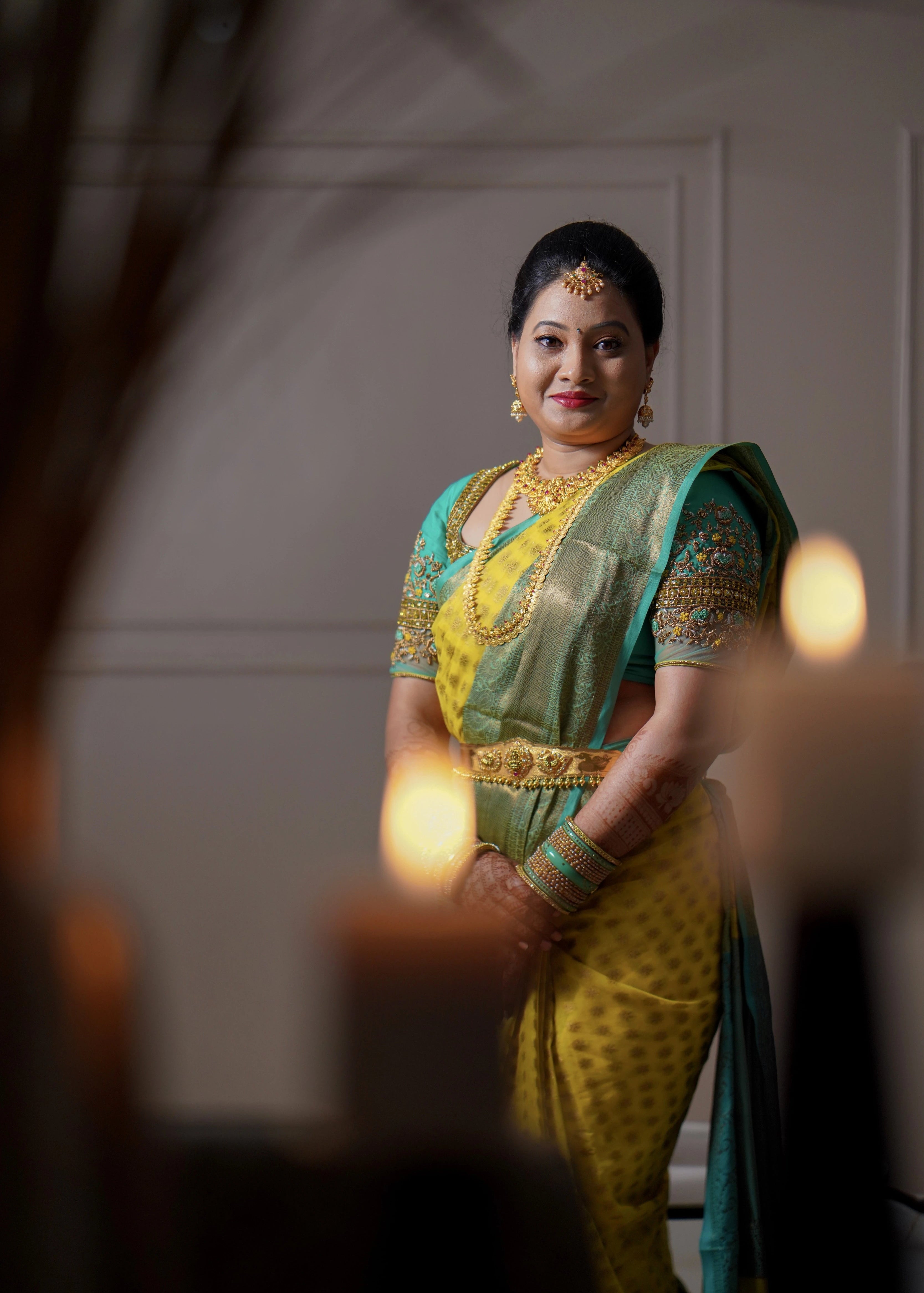 Bride from Seattle smilingfor front profile in an aquamarine blouse designed by Archana Karthick