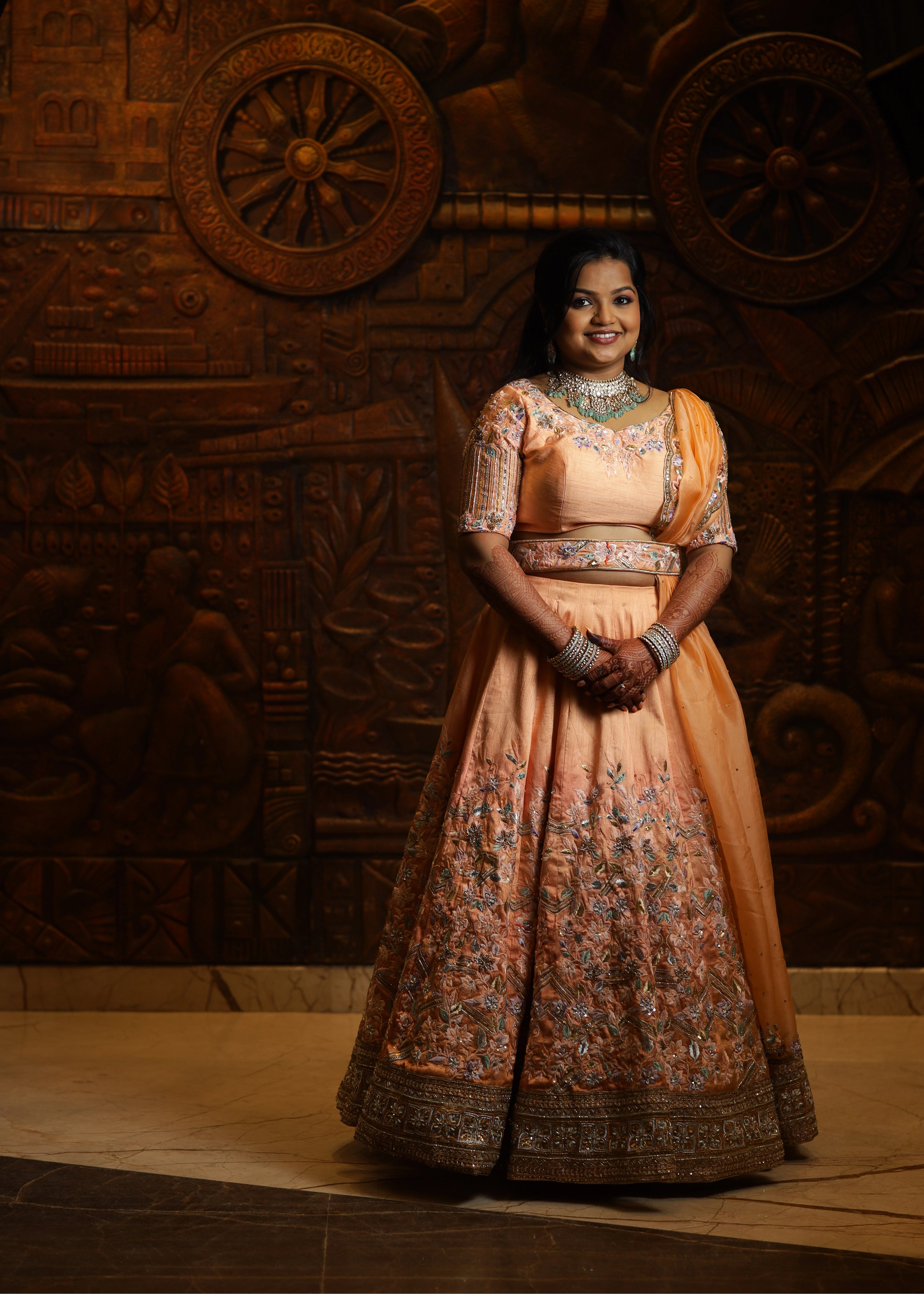 Bride from Singapore in a handcrafted peach lehenga designed by Archana Karthick