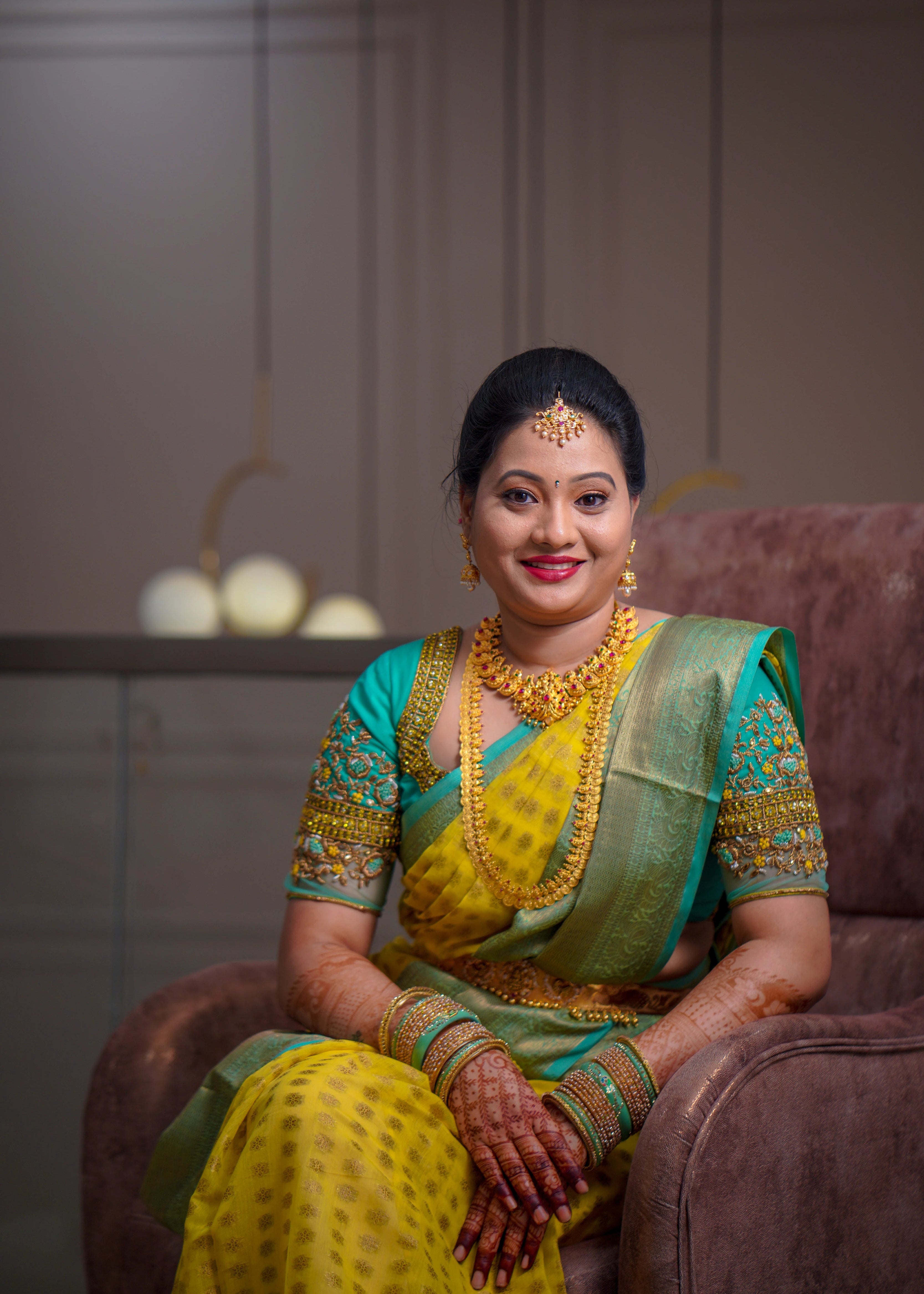 Bride from USA posing in an aquamarine blouse designed by Archana Karthick