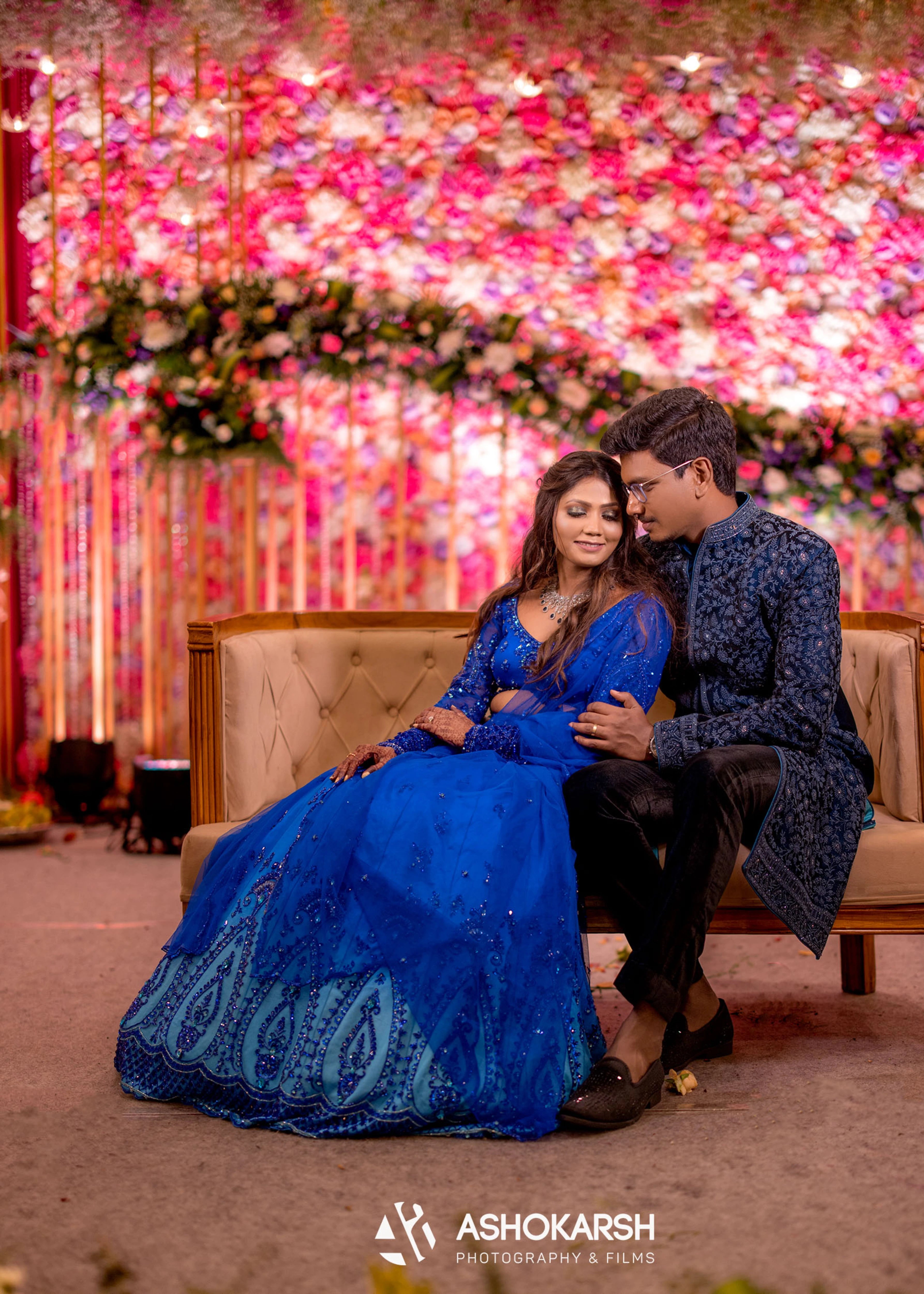 Bride from USA posing with the groom in a concept blue lehenga handcrafted intricately with rhinestones, crystal beads, cutdanas and sequins.