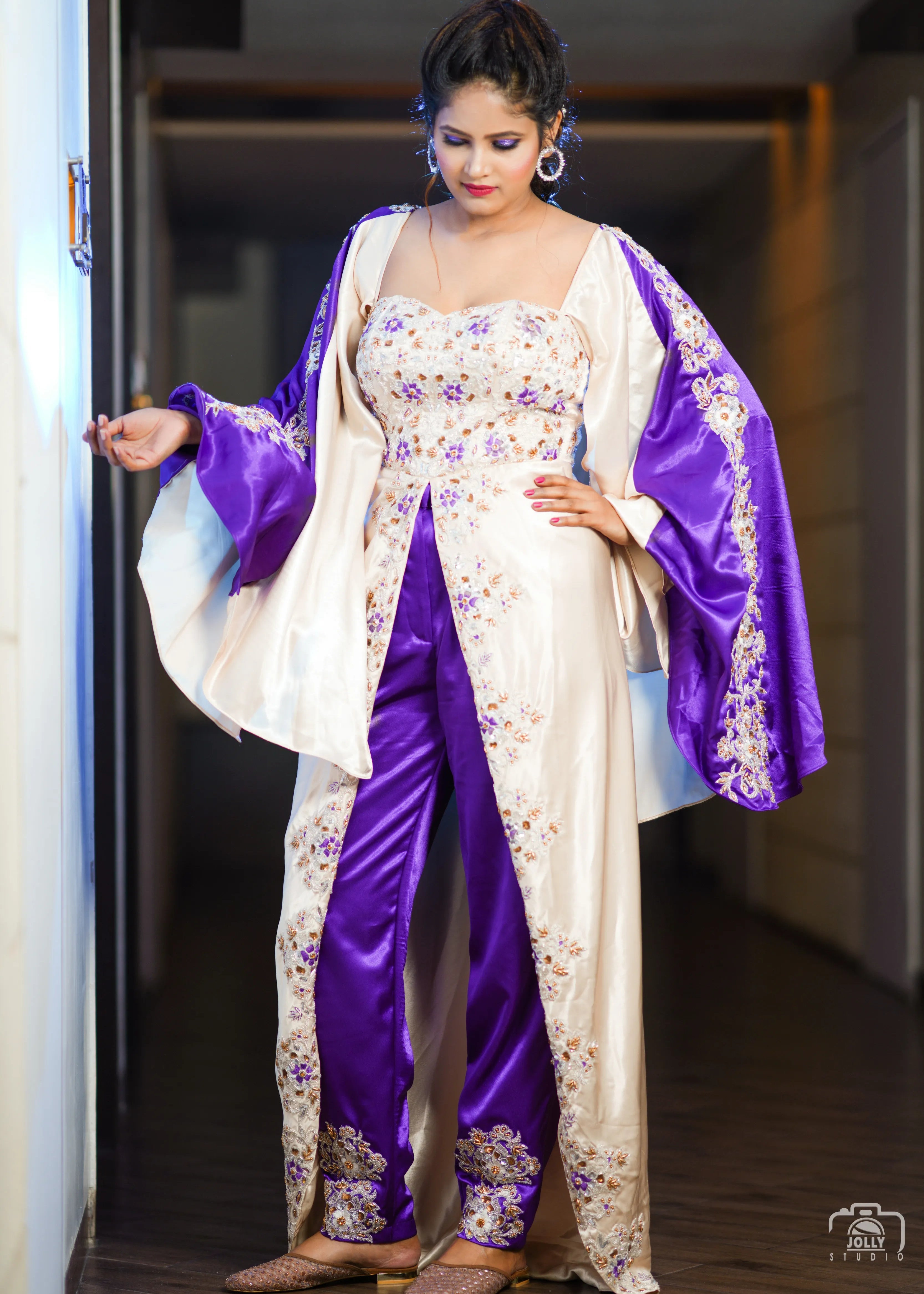 Bride in a handcrafted satin silk corset outfit (corset x masakali x kimono fusion) embellished with cut dana, sequins, beads and resham embellishments. Posing for her sangeet party.
