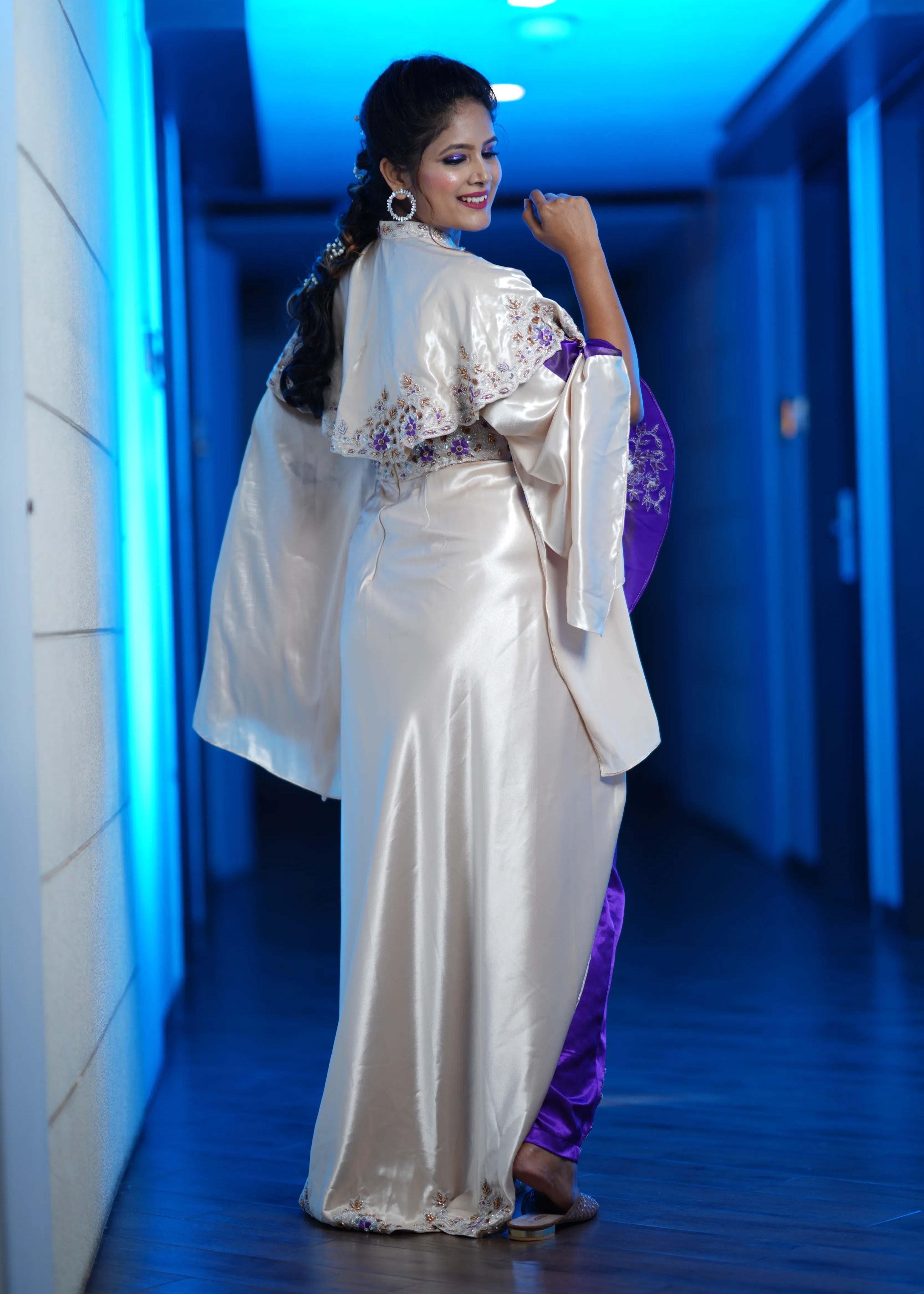 Bride in a handcrafted satin silk corset outfit (corset x masakali x kimono fusion) embellished with cut dana, sequins, beads and resham embellishments. Showcasing back design for her sangeet photoshoot.