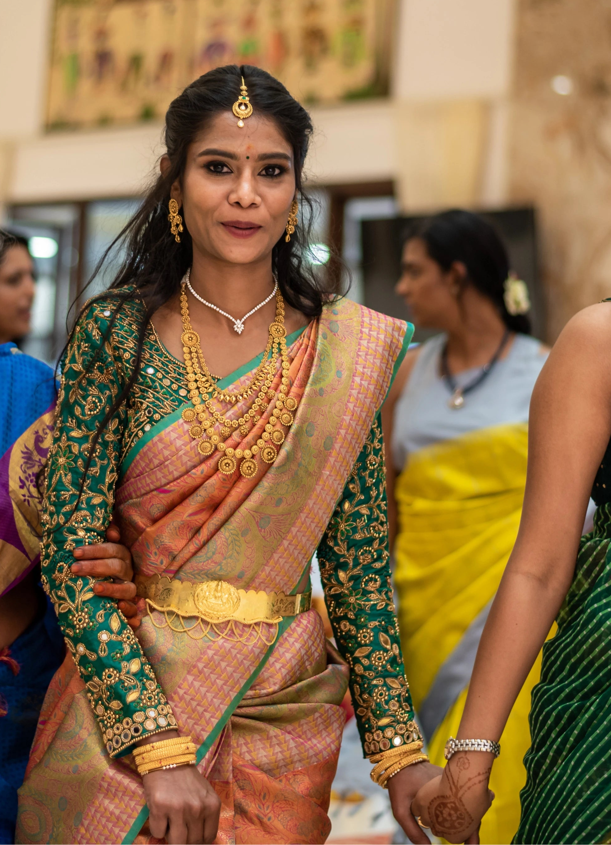 Bride in full sleeves green blouse for her wedding rituals designed by Archana Karthick
