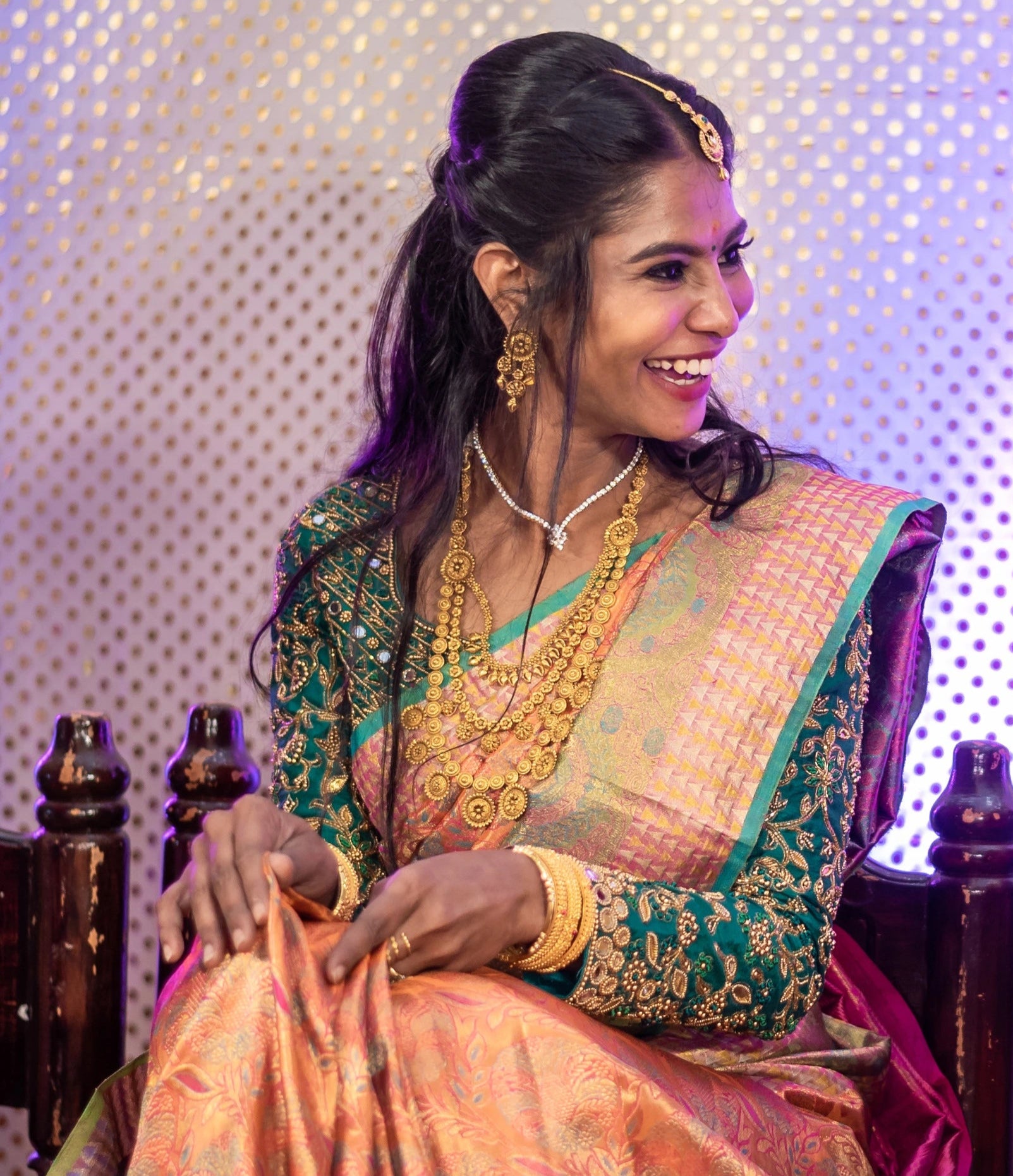 Bride laughinig in full sleeves green blouse for her wedding rituals designed by Archana Karthick