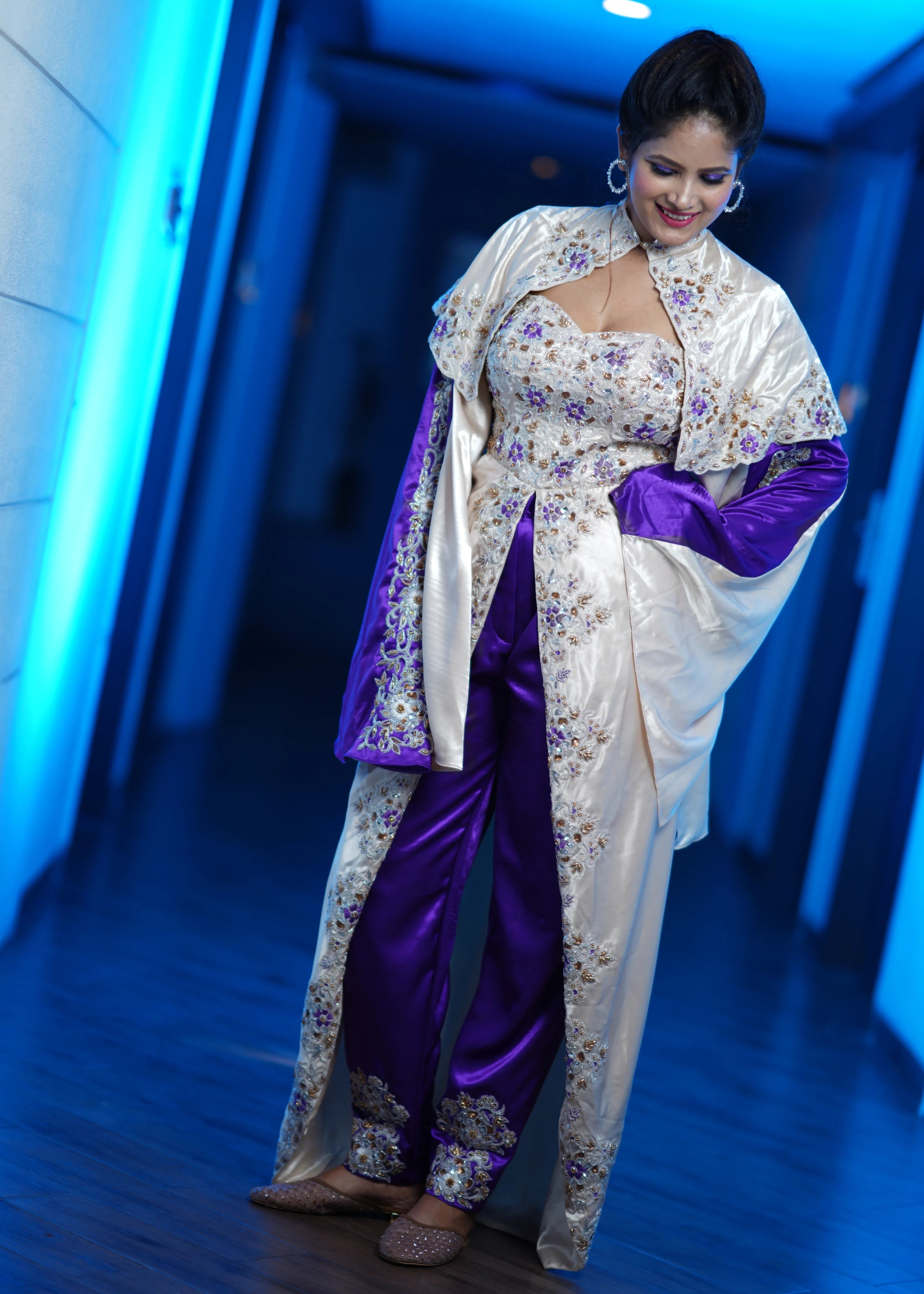 Bride posing in a handcrafted satin silk corset outfit (corset x masakali x kimono fusion) embellished with cut dana, sequins, beads and resham embellishments. This was designed for her sangeet party.