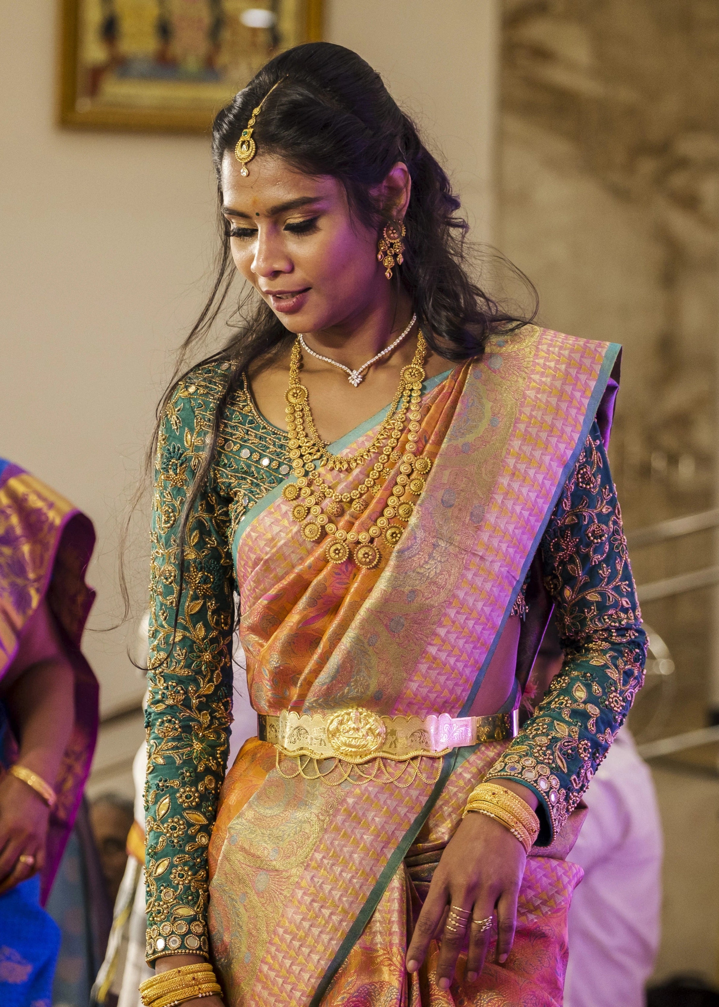 Bride posing in full sleeves green blouse for her wedding rituals designed by Archana Karthick