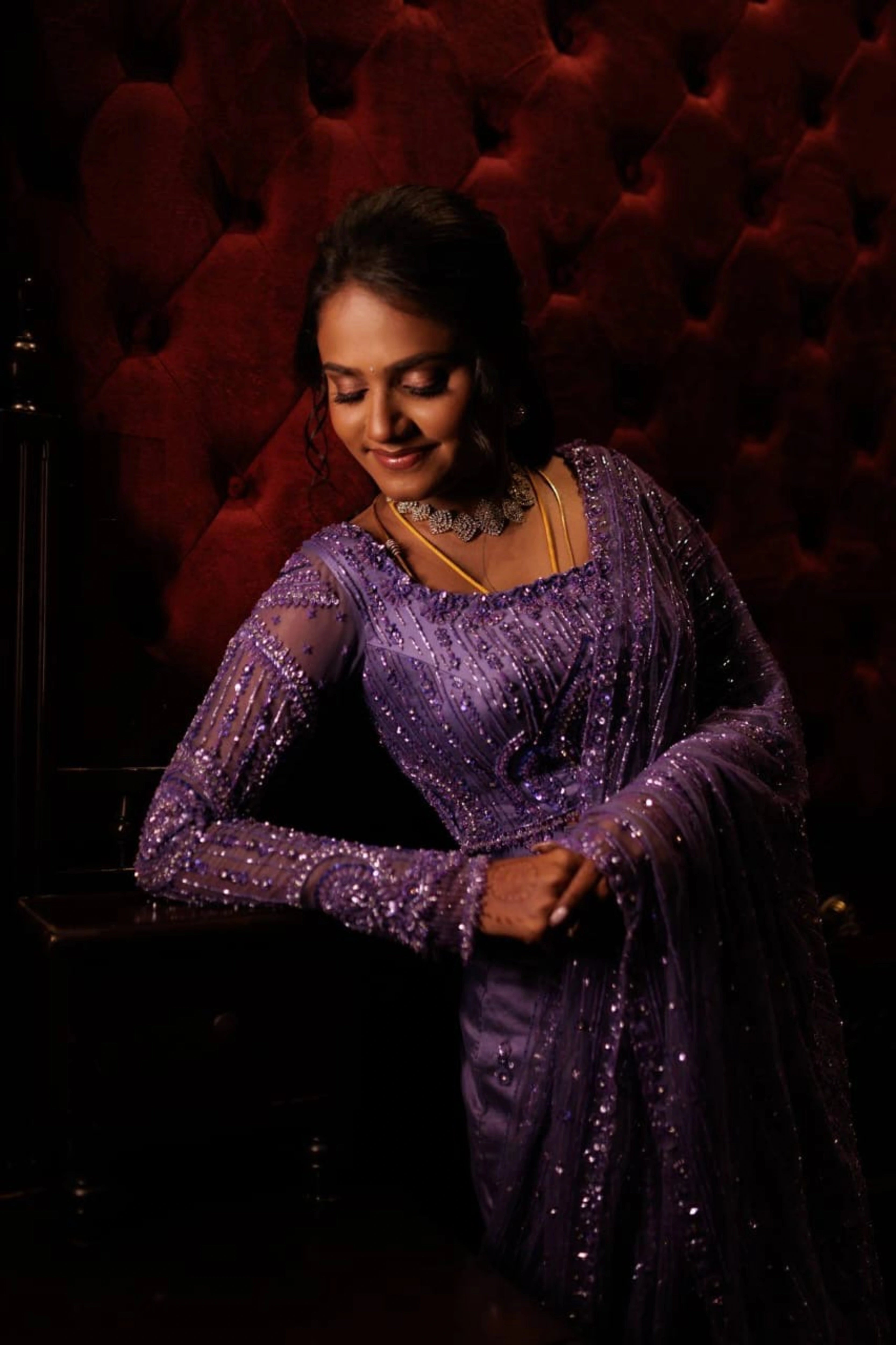 Bride Vishnu Karthika smiling in a lavender tulle draped saree, handcrafted with rhinestones, zardozi, sequins, crystals, cutdana and resham by team Archana Karthick.