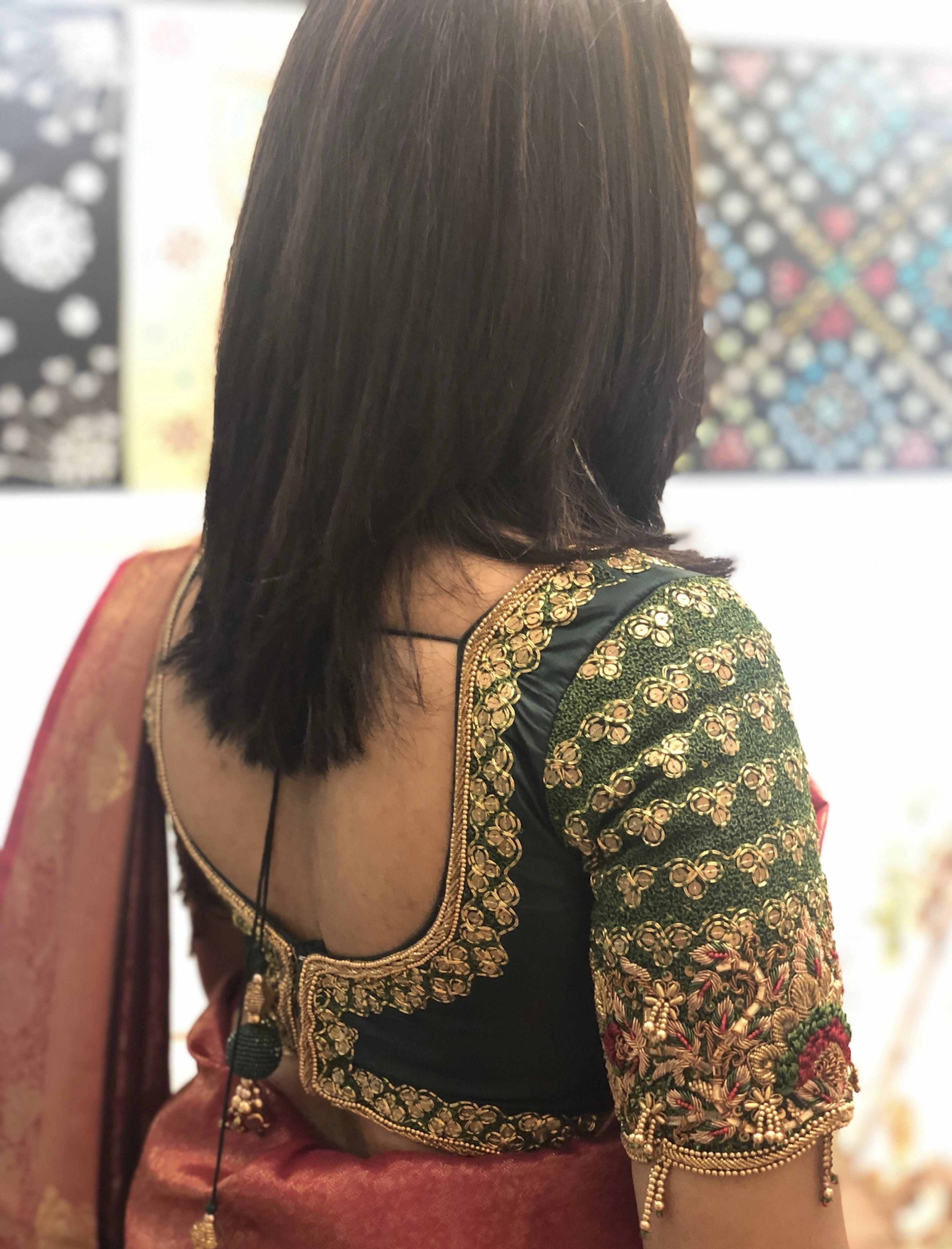 Bridesmaid Abhinaya during fittings in a green silk blouse, handcrafted by team Archana Karthick.