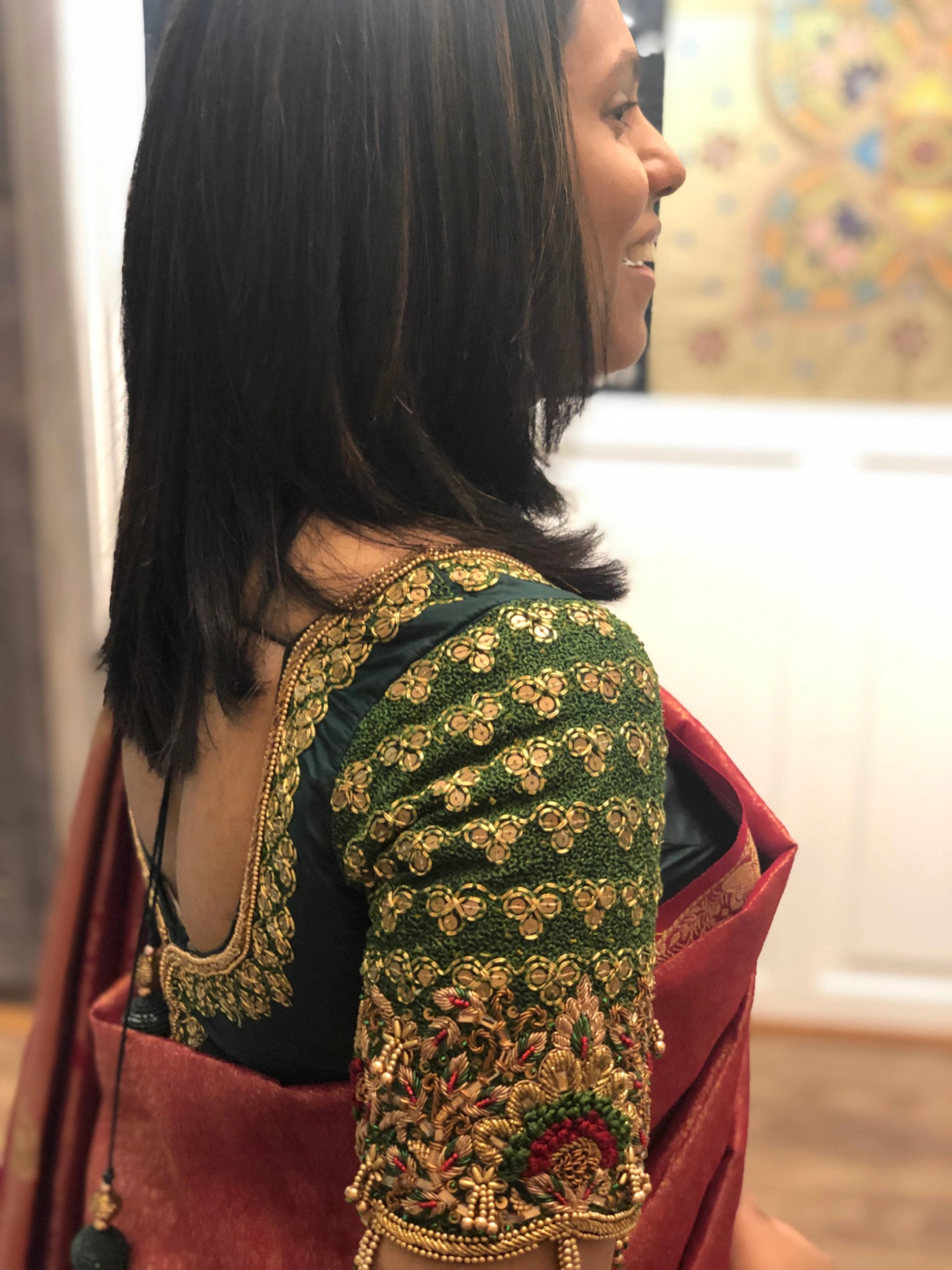 Bridesmaid Abhinaya in a green silk blouse, handcrafted by team Archana Karthick.