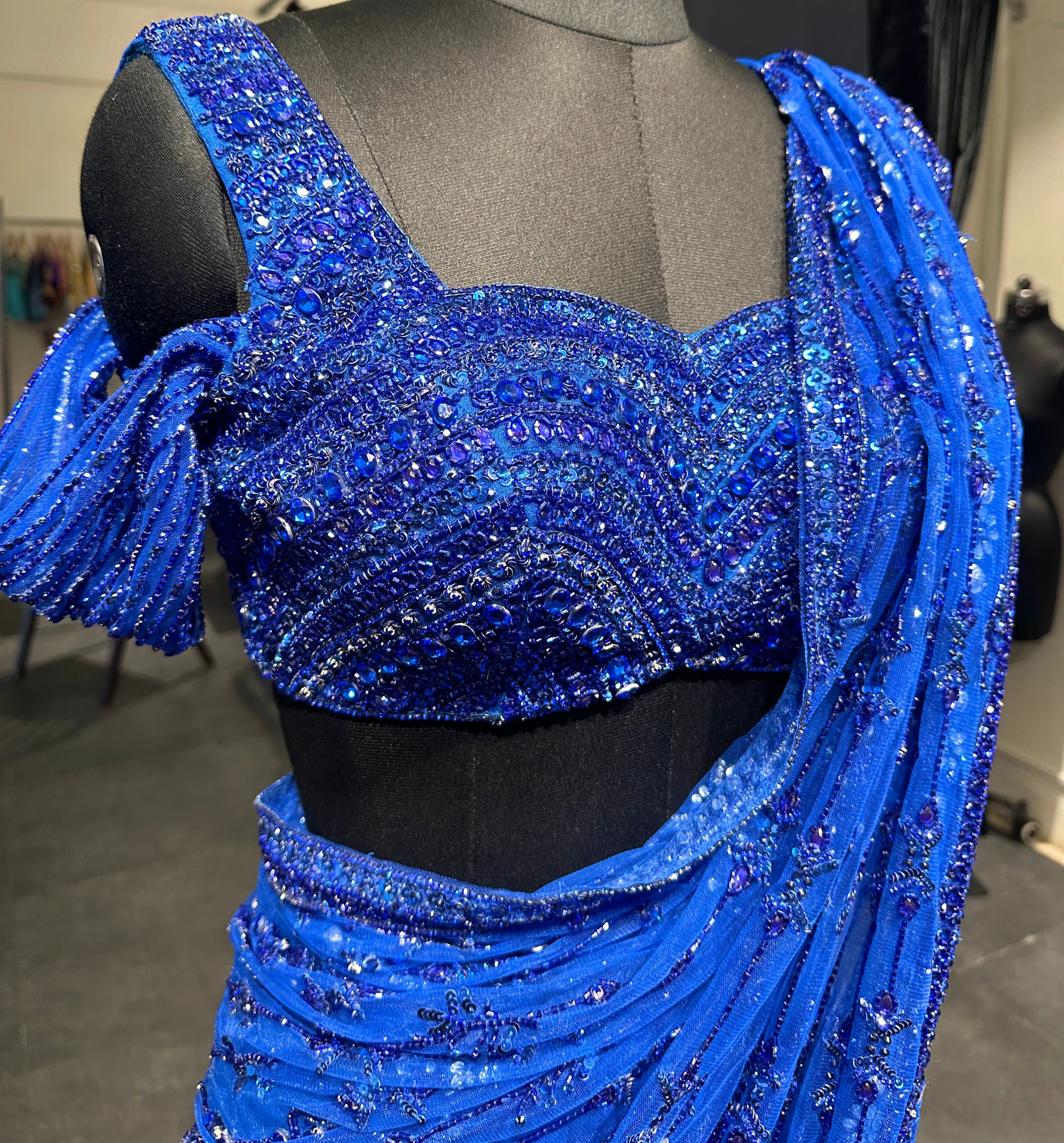 Bridesmaid Gouthami's blue tulle saree detailing photo in the studio, handcrafted by team Archana Karthick.