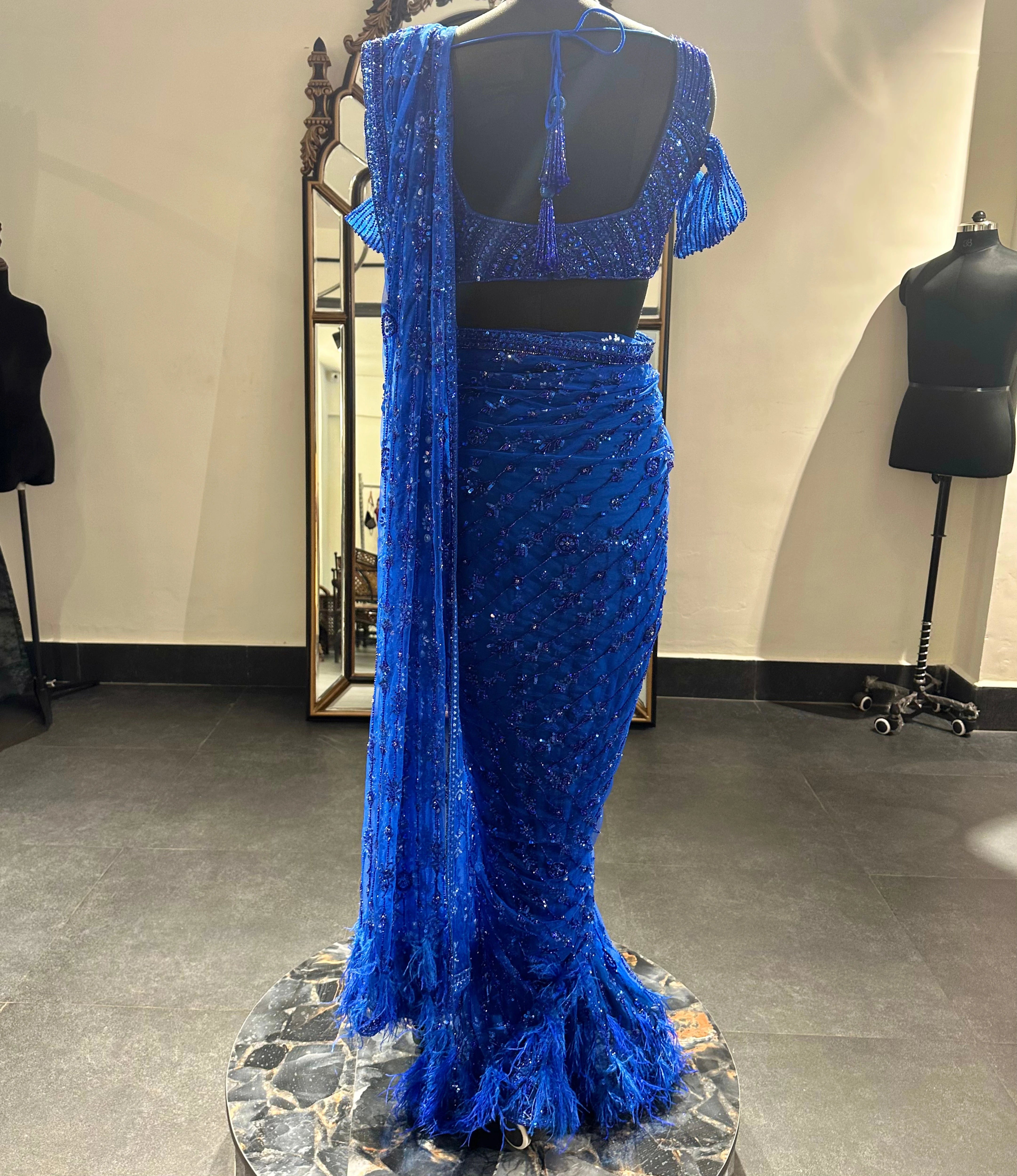 Bridesmaid Gouthami's blue tulle saree in the studio, handcrafted by team Archana Karthick.