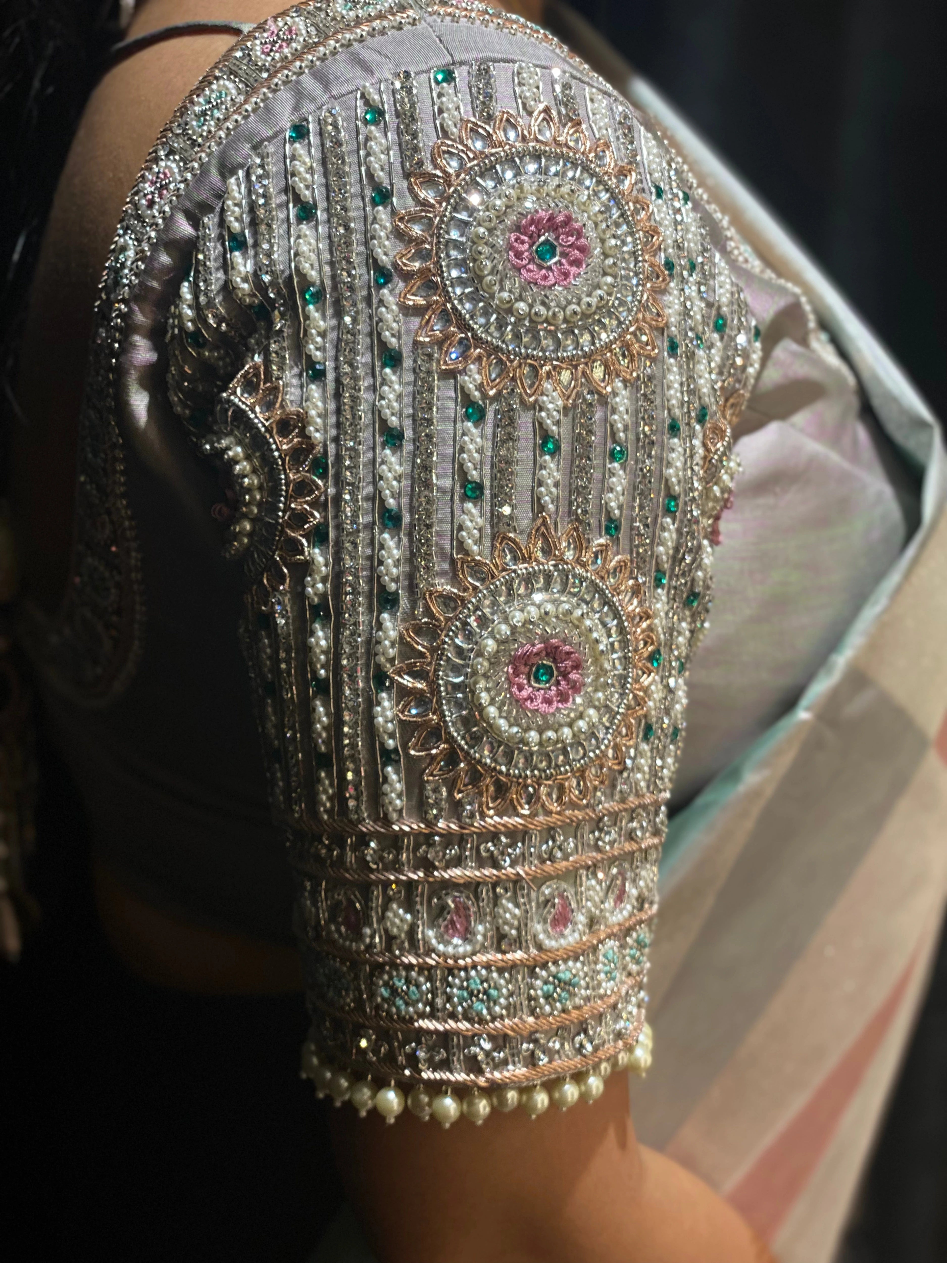 Bridesmaid Jayanti in a silver silk blouse, handcrafted by team Archana Karthick.