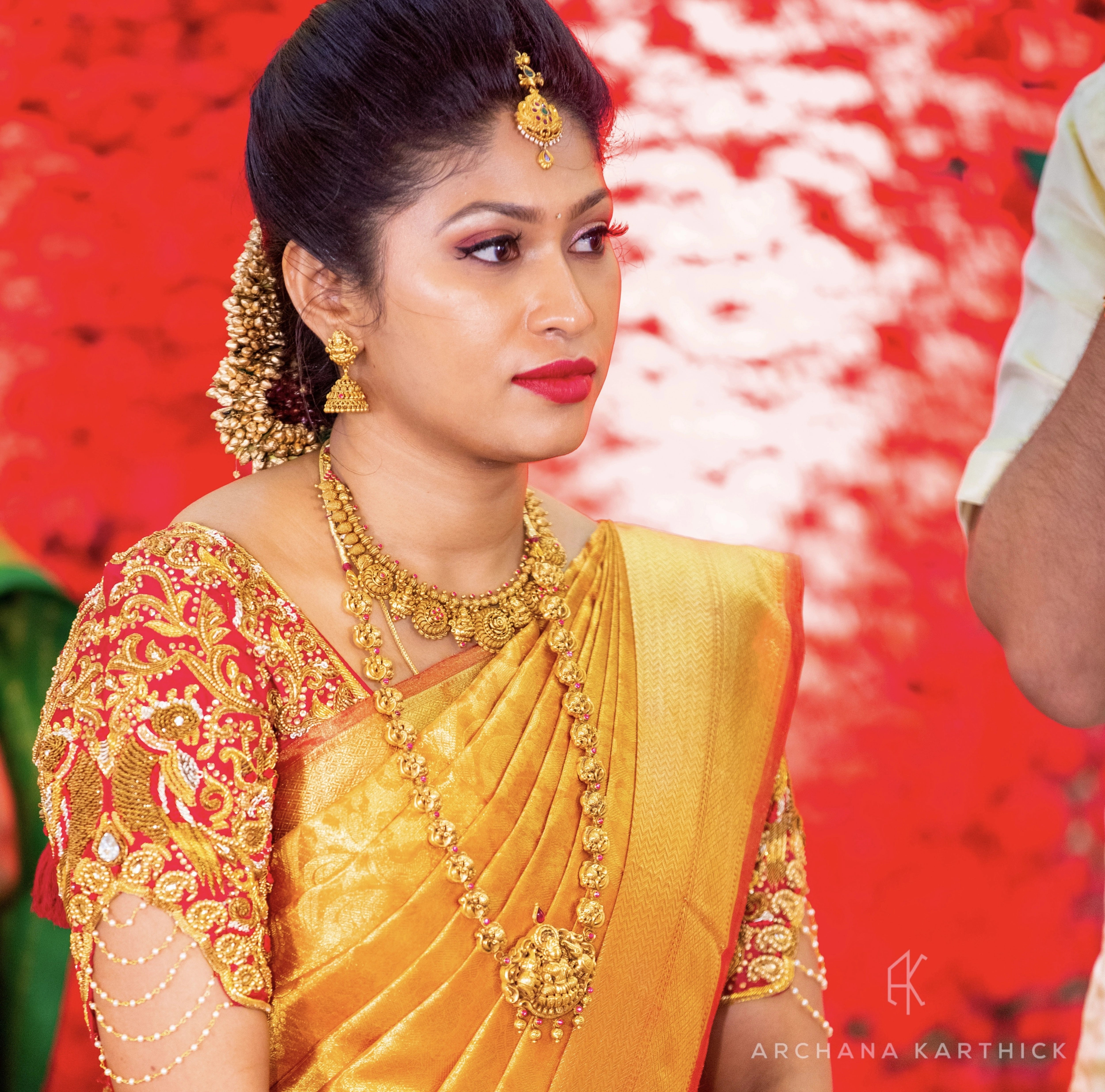 Bridesmaid Manju from Australia in a red silk blouse by team Archana Karthick