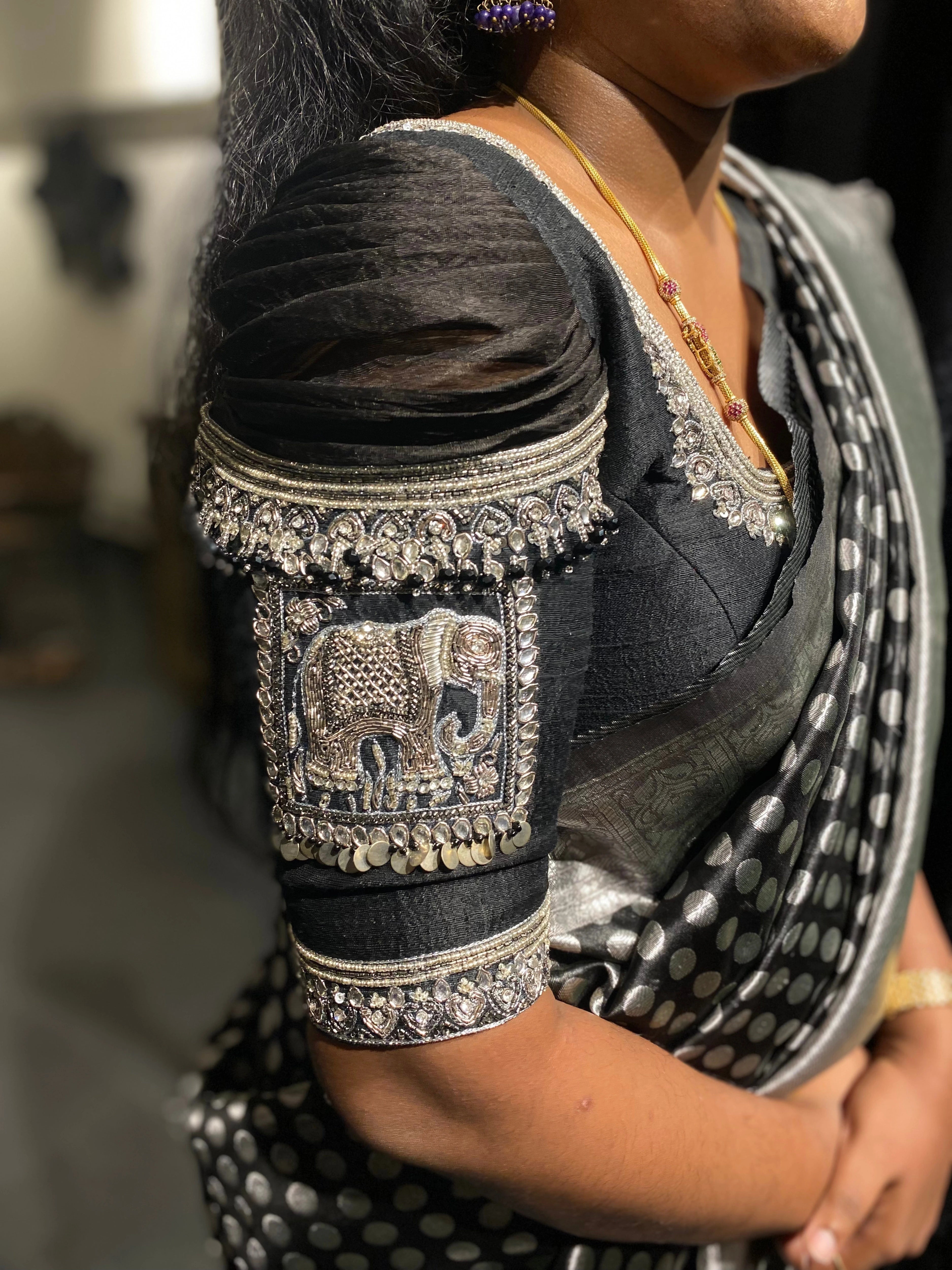 Bridesmaid Nagalakshmi during the fittings in a black rawsilk blouse, handcrafted by team Archana Karthick.
