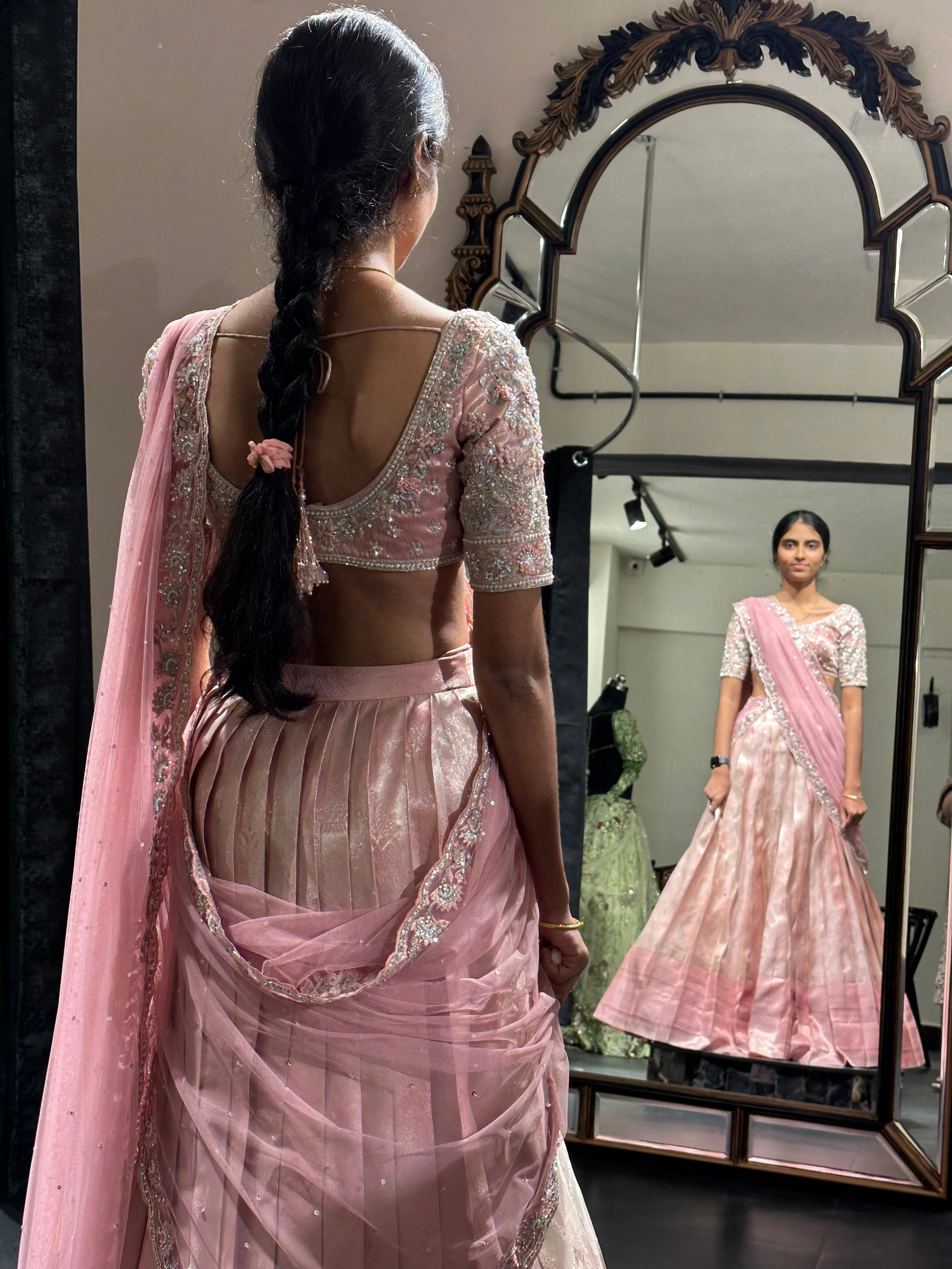 Bridesmaid Nirupama during her fittings in an onion pink half saree, handcrafted by team Archana Karthick.