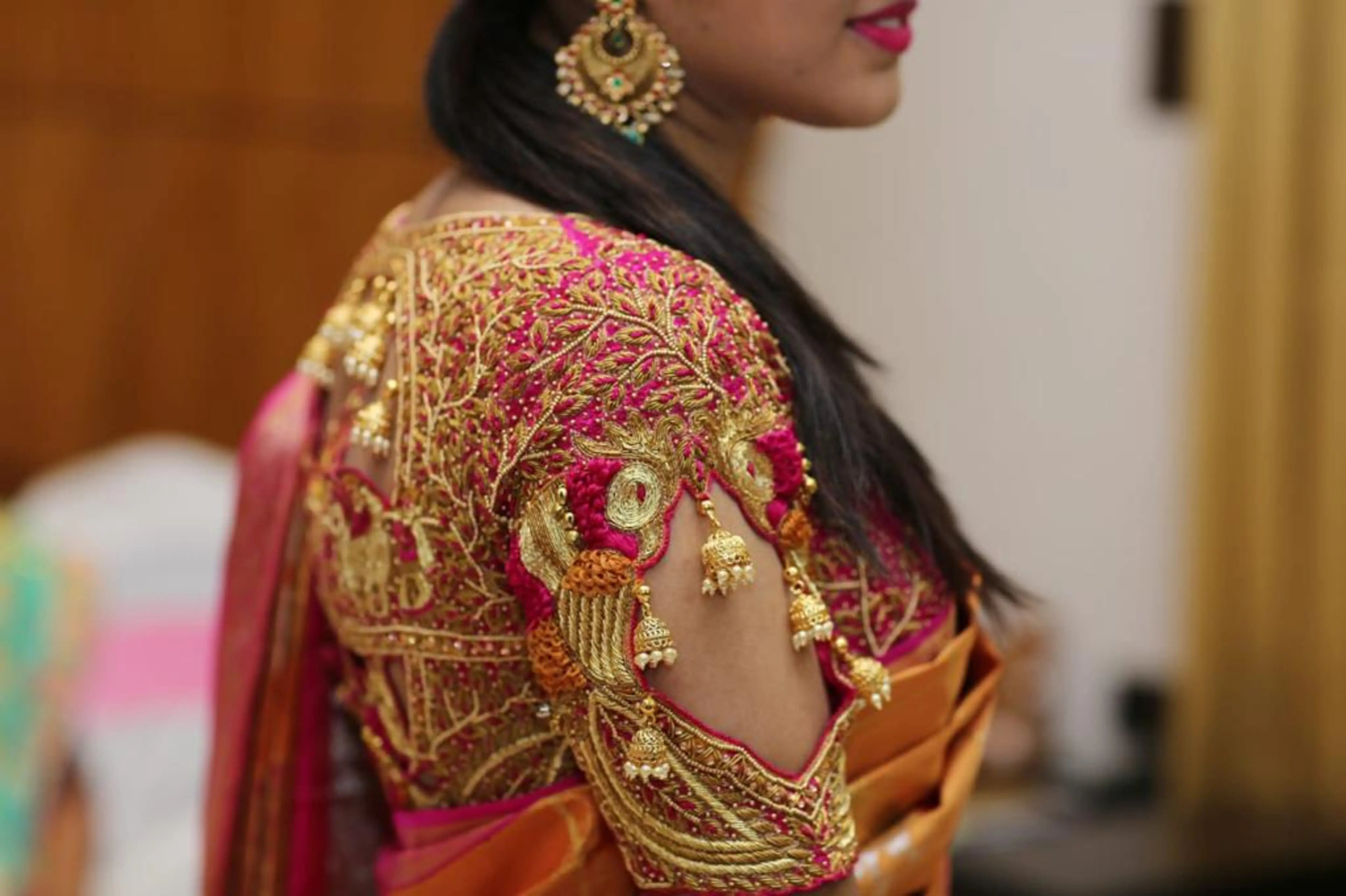 Bridesmaid Nivetha in a palanquin concept raspberry silk blouse, intricately handcrafted with zardozi, beads, resham, coins and more by team Archana Karthick.