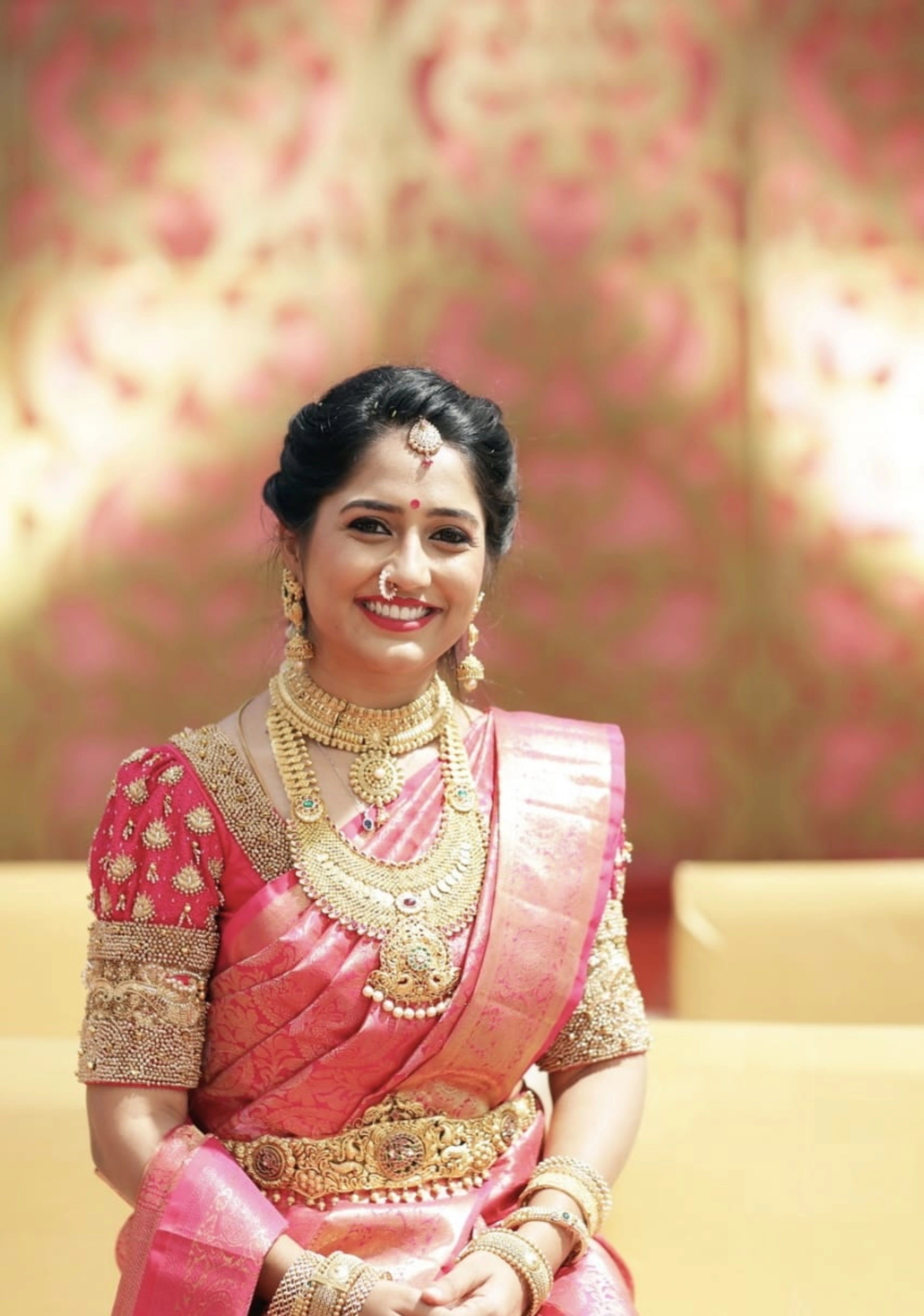 Bridesmaid Nivetha in a puff sleeved silk blouse, intricately handcrafted with zardozi, beads, resham knot work, beads, and ghungroos by team Archana Karthick.