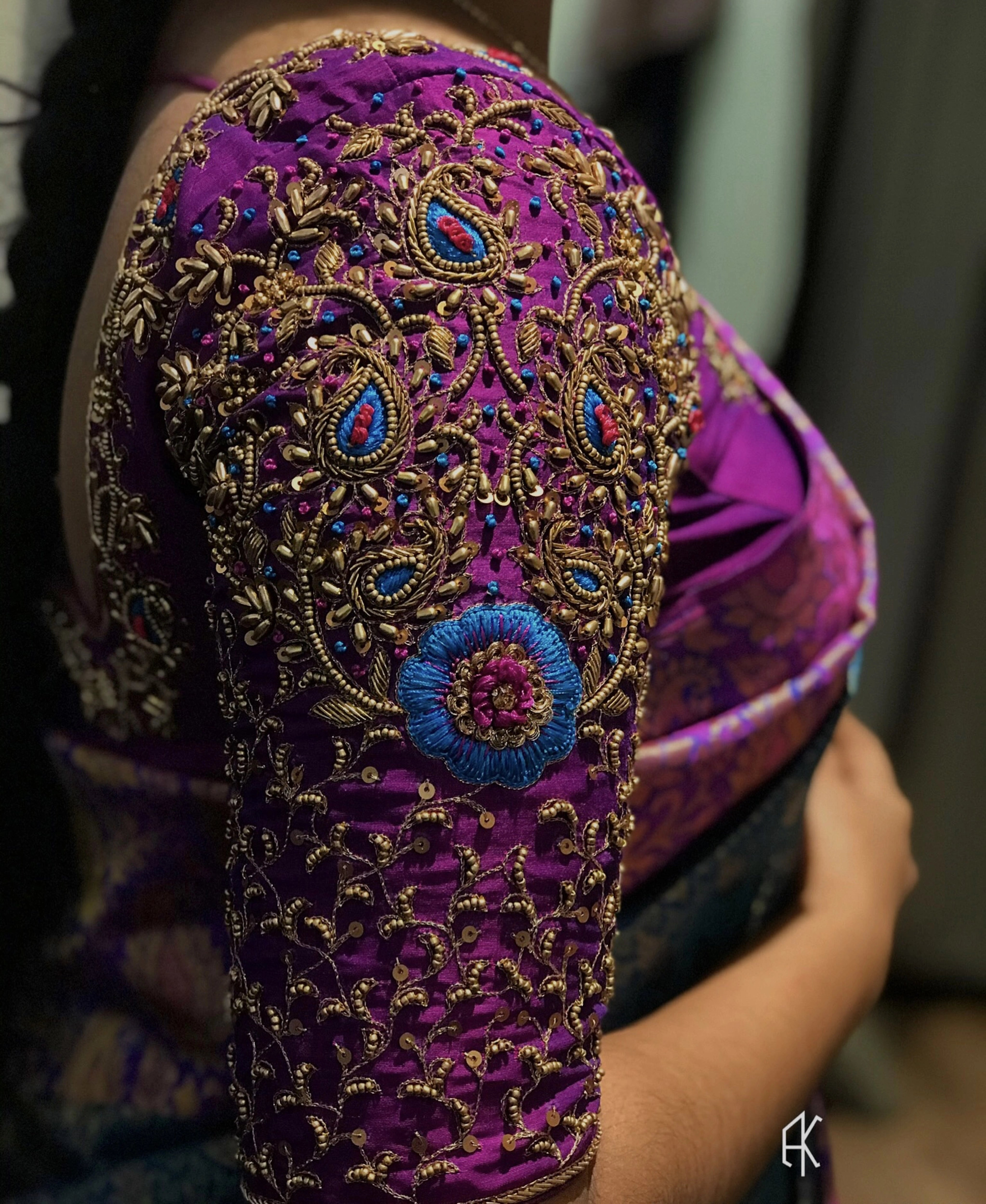 Bridesmaid Sai Janani in a magenta silk blouse, handcrafted by team Archana Karthick.