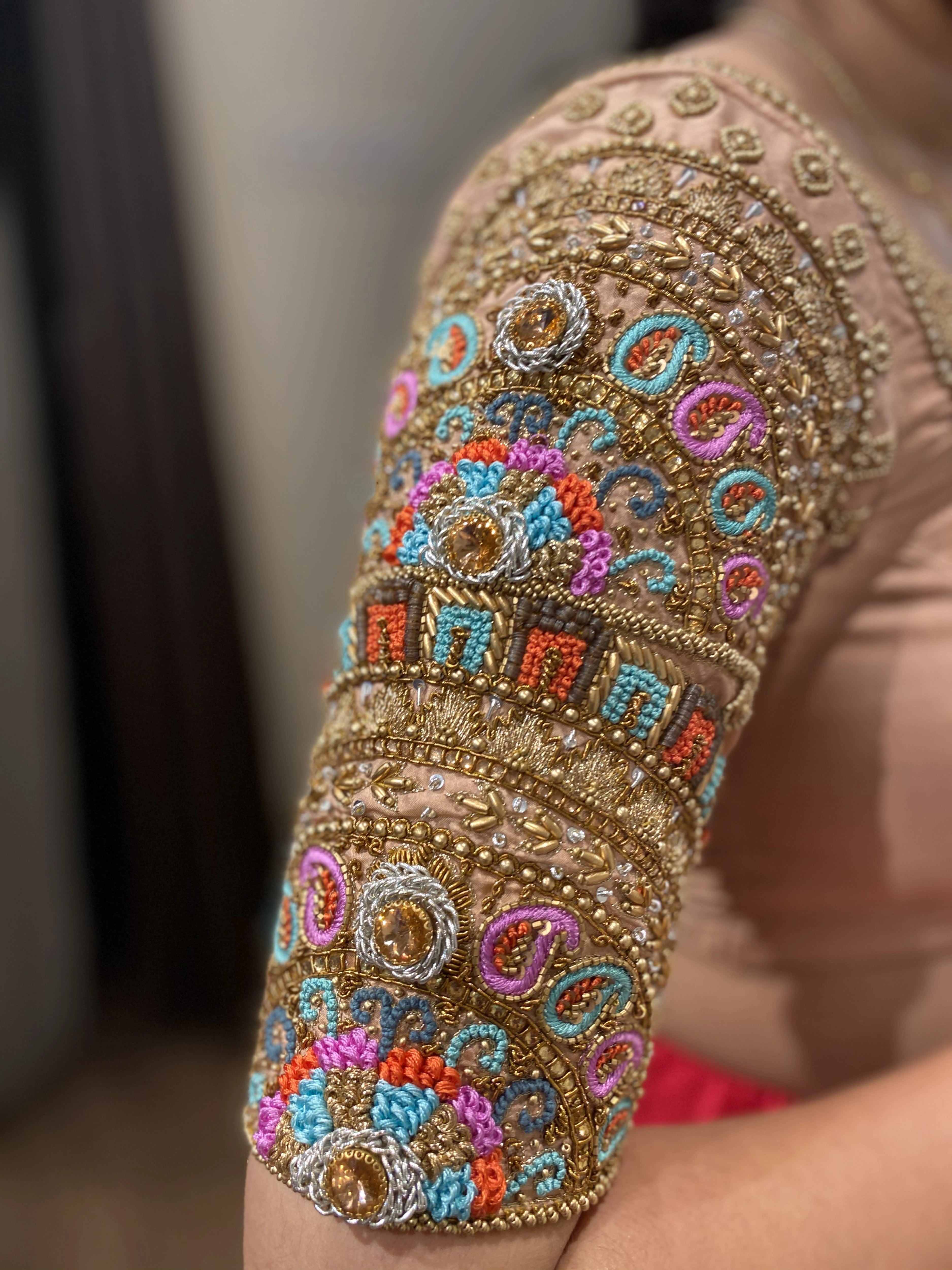 Bridesmaid Sai Teju in a peach cream silk blouse, handcrafted by team Archana Karthick.