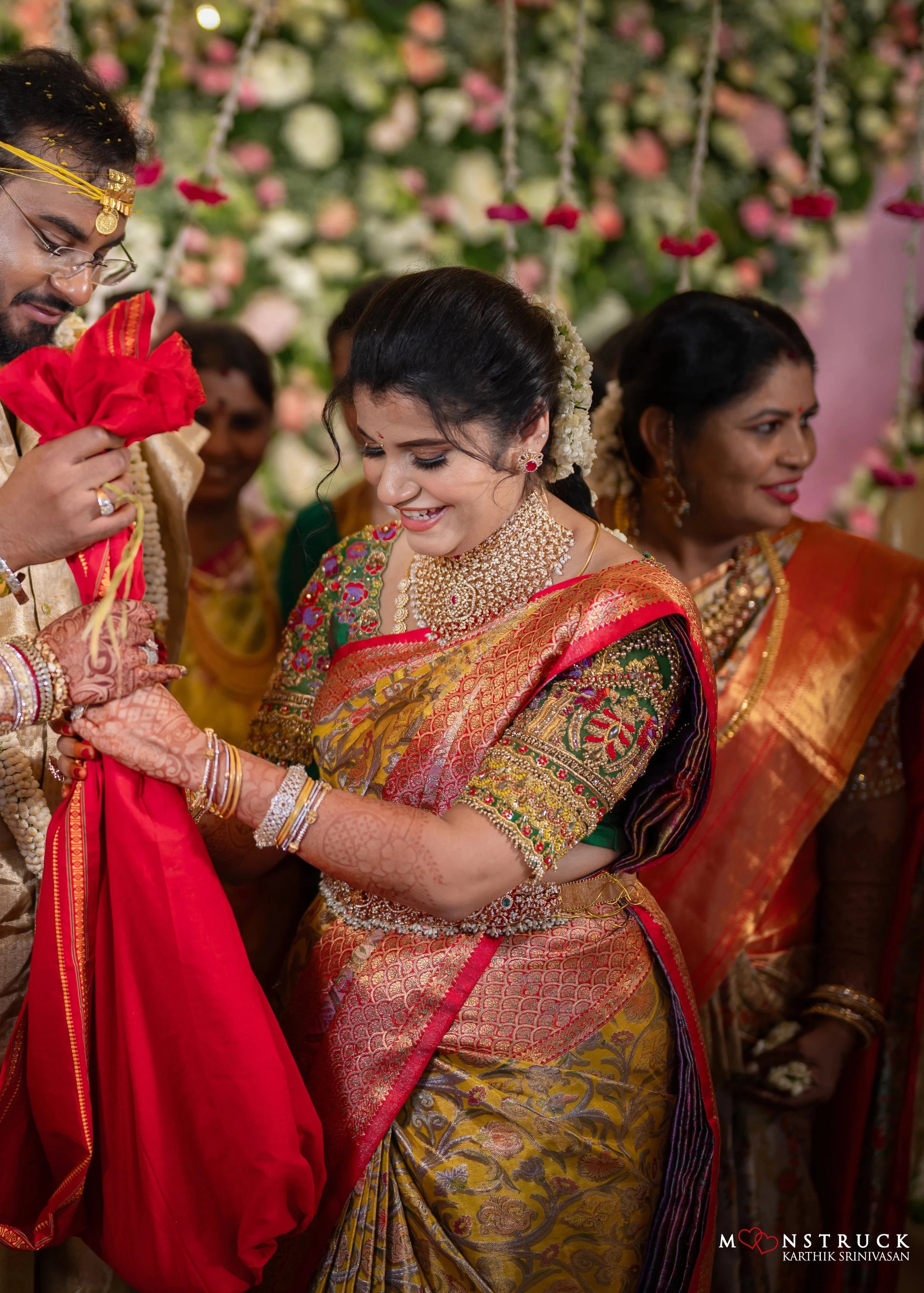 Bridesmaid Sanjana Sujith posing in a green silk blouse intricately handcrafted with resham, zardozi, sequins, beads, crystals and stones by Archana Karthick.