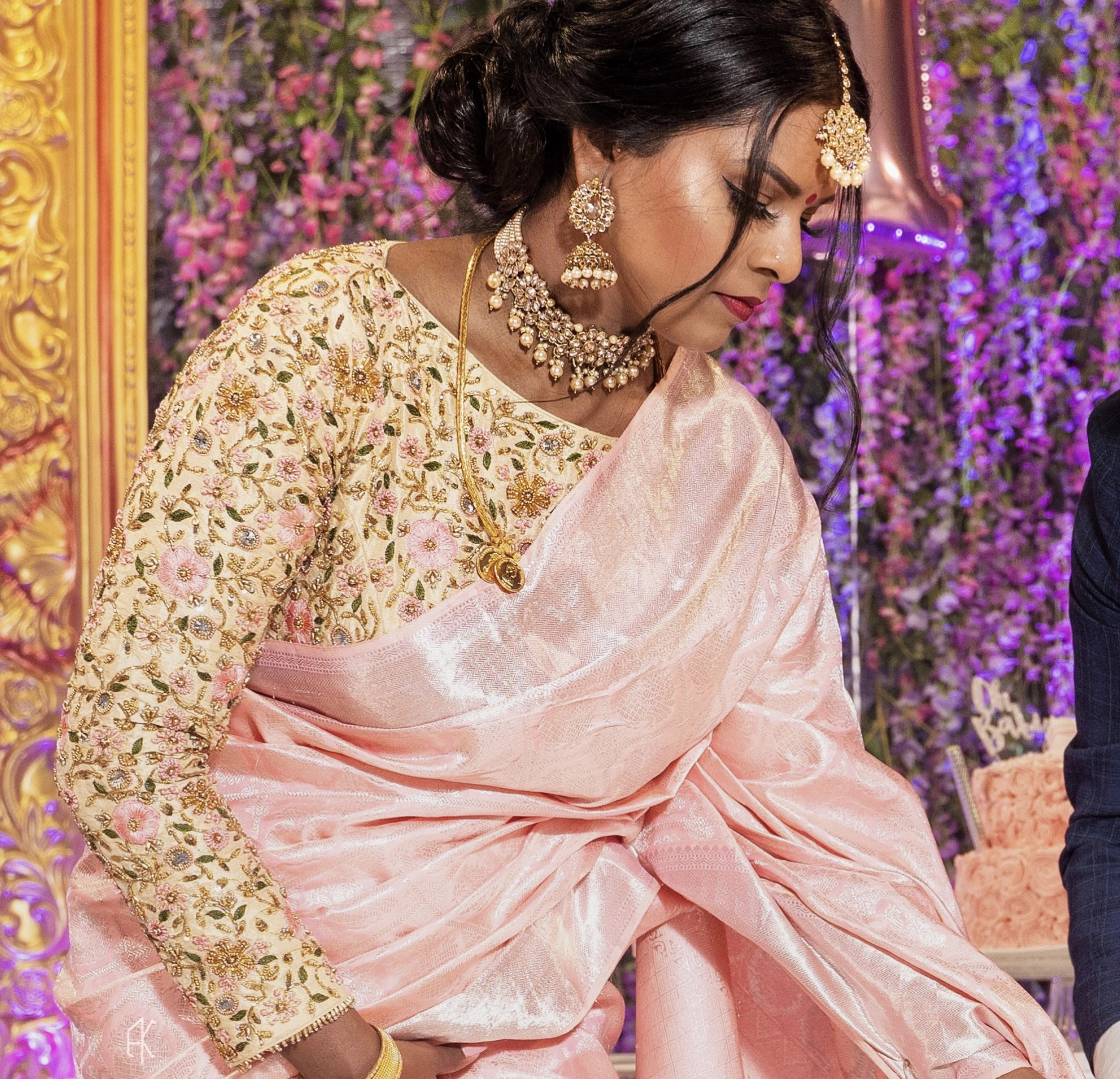 Bridesmaid Shana from Switzerland in a cream silk blouse, handcrafted by team Archana Karthick.