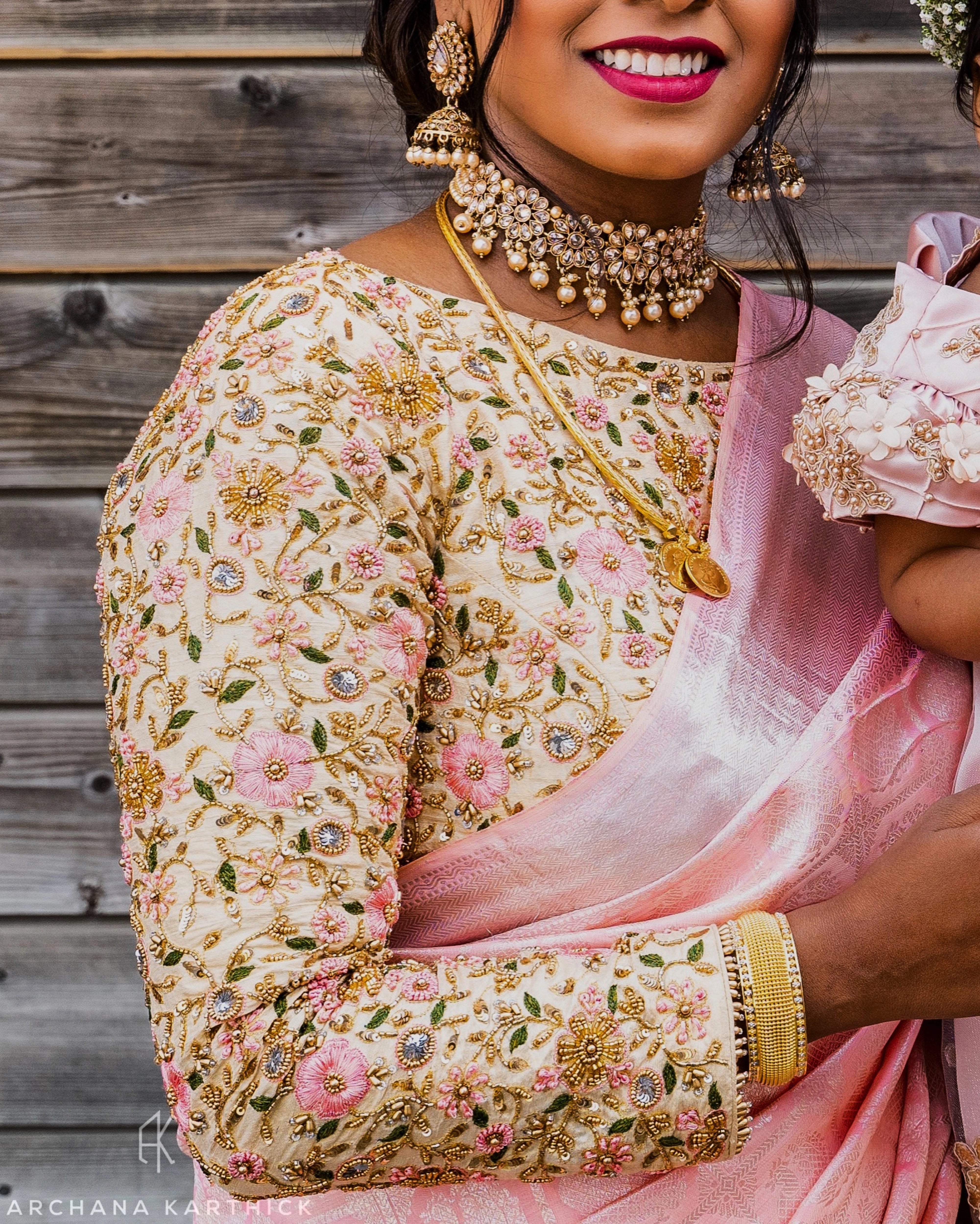 Bridesmaid Shana from Switzerland posing in a cream silk blouse, handcrafted by team Archana Karthick.