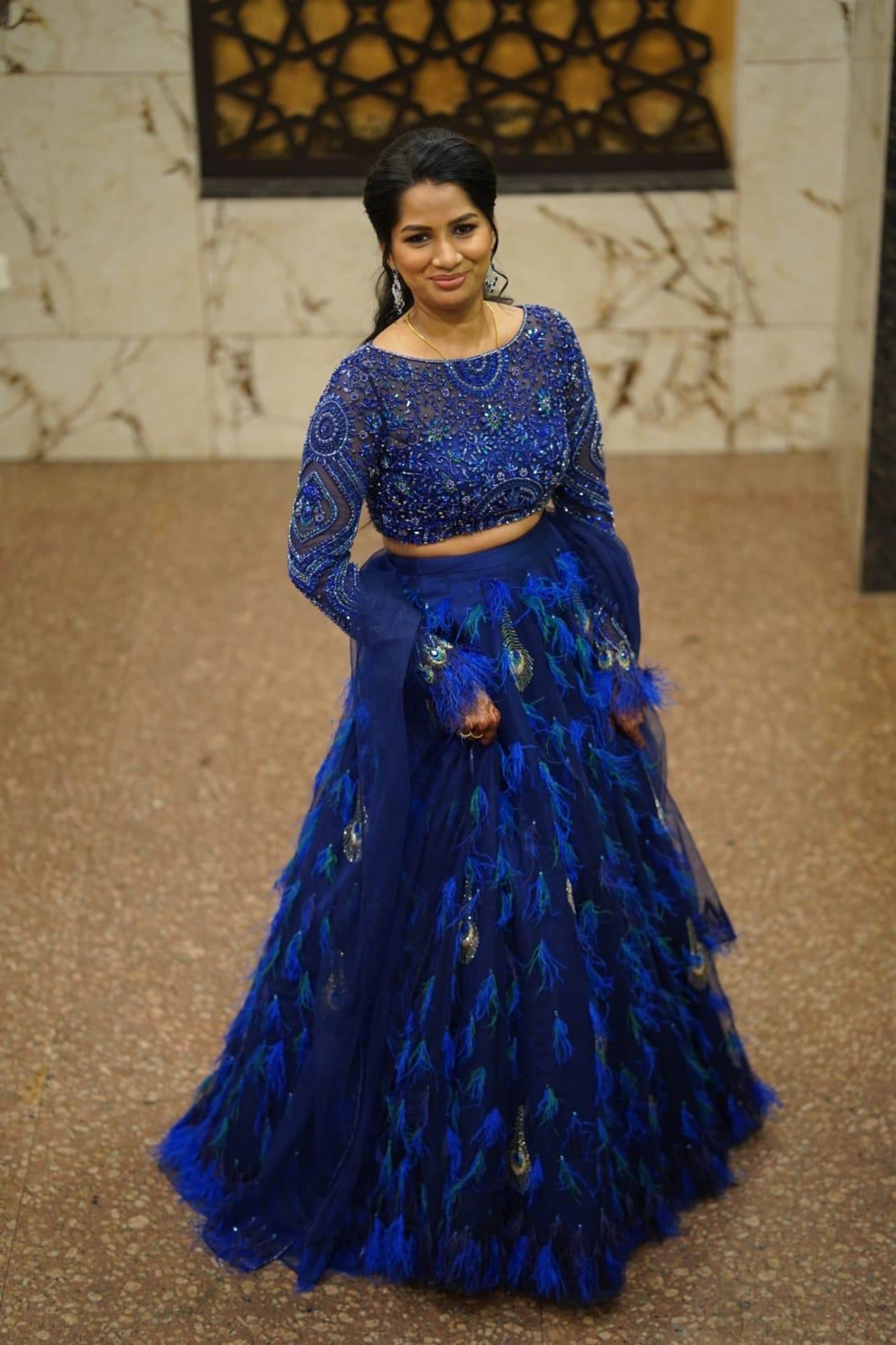 Bridesmaid Sowmiya Rajeev from Singapore, in a peacock lehenga by team Archana Karthick