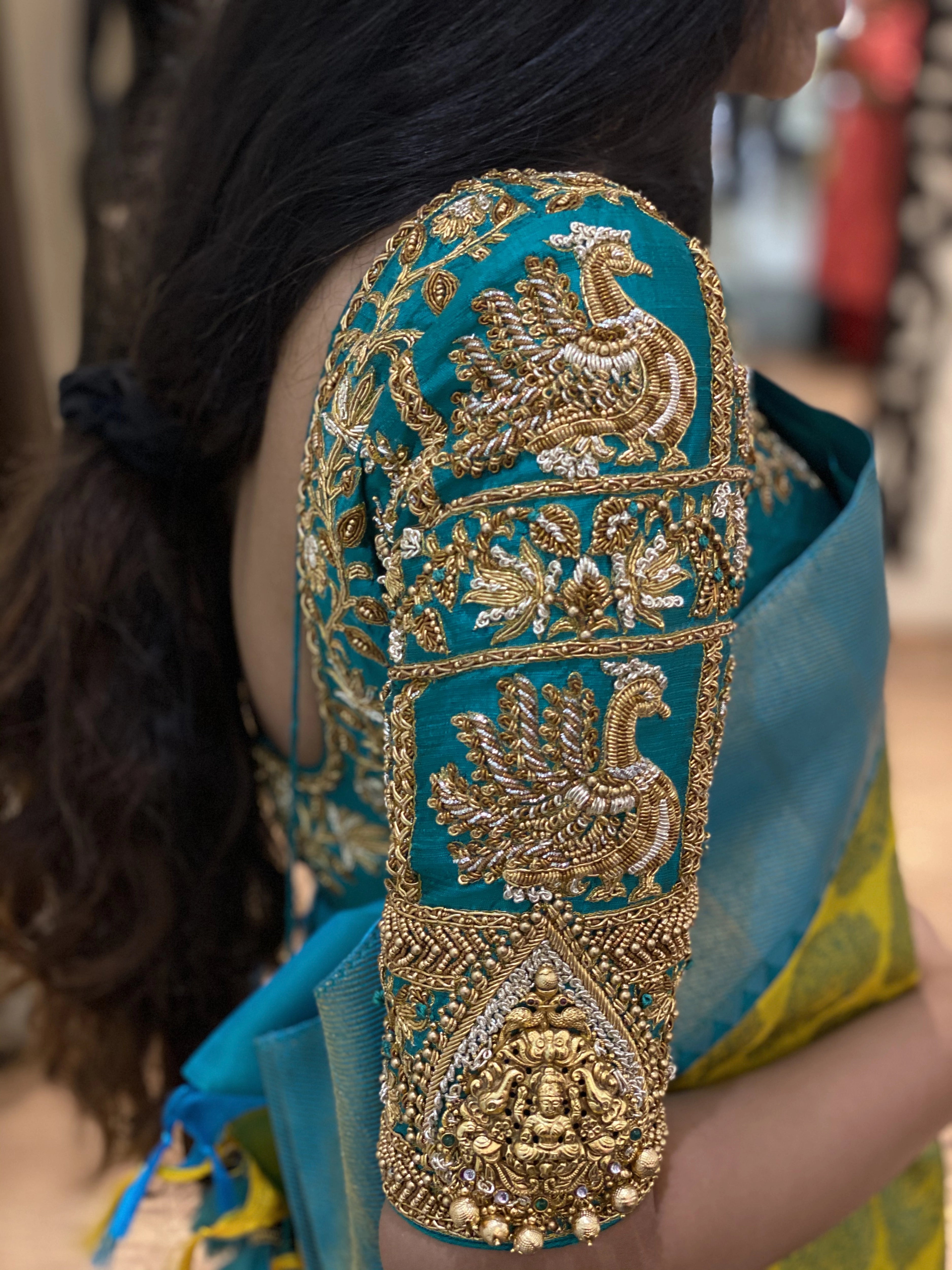 Bridesmaid Varsha during her fittings in a teal silk blouse, handcrafted by team Archana Karthick.