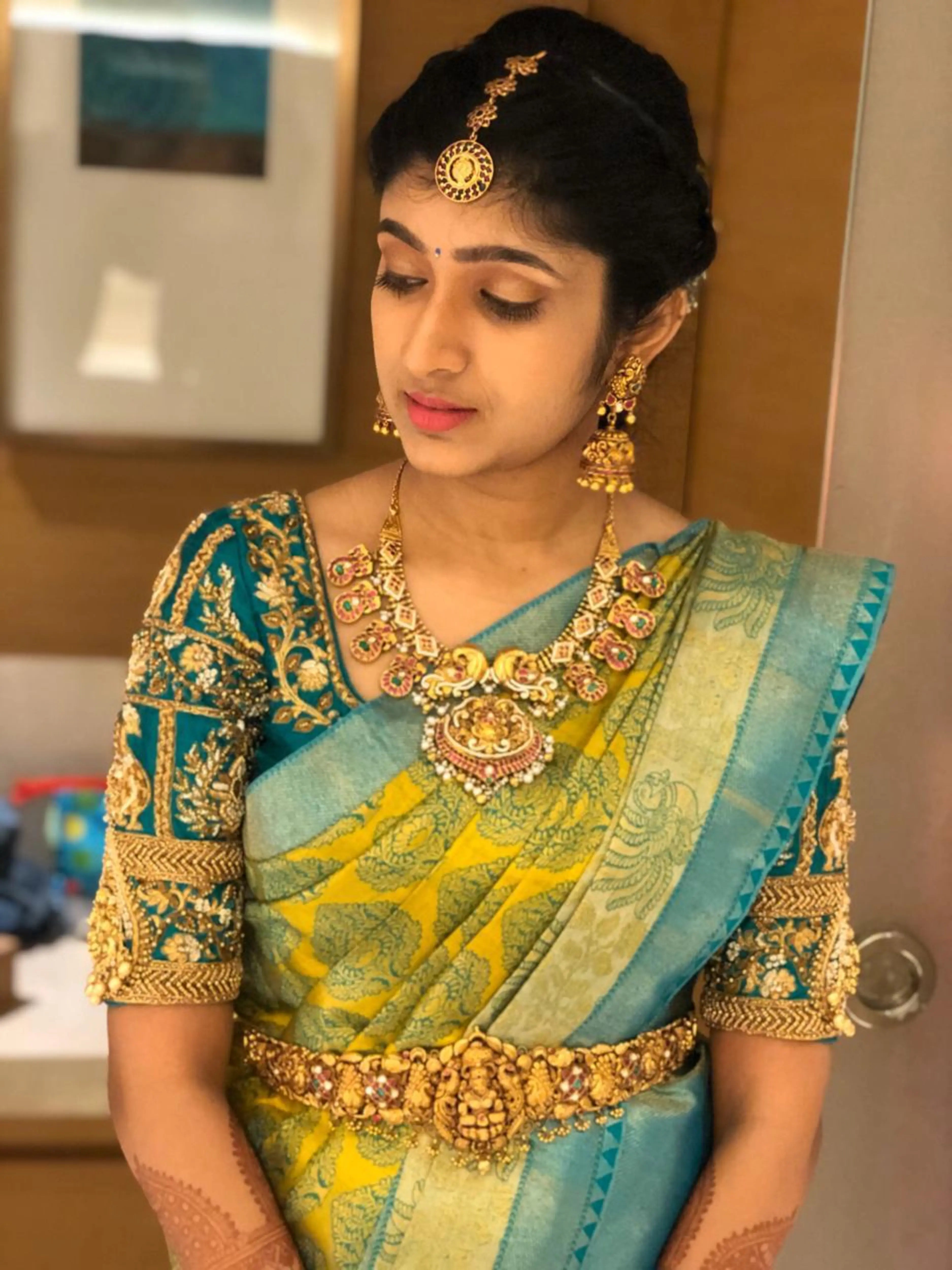 Bridesmaid Varsha in a teal silk blouse, handcrafted by team Archana Karthick.