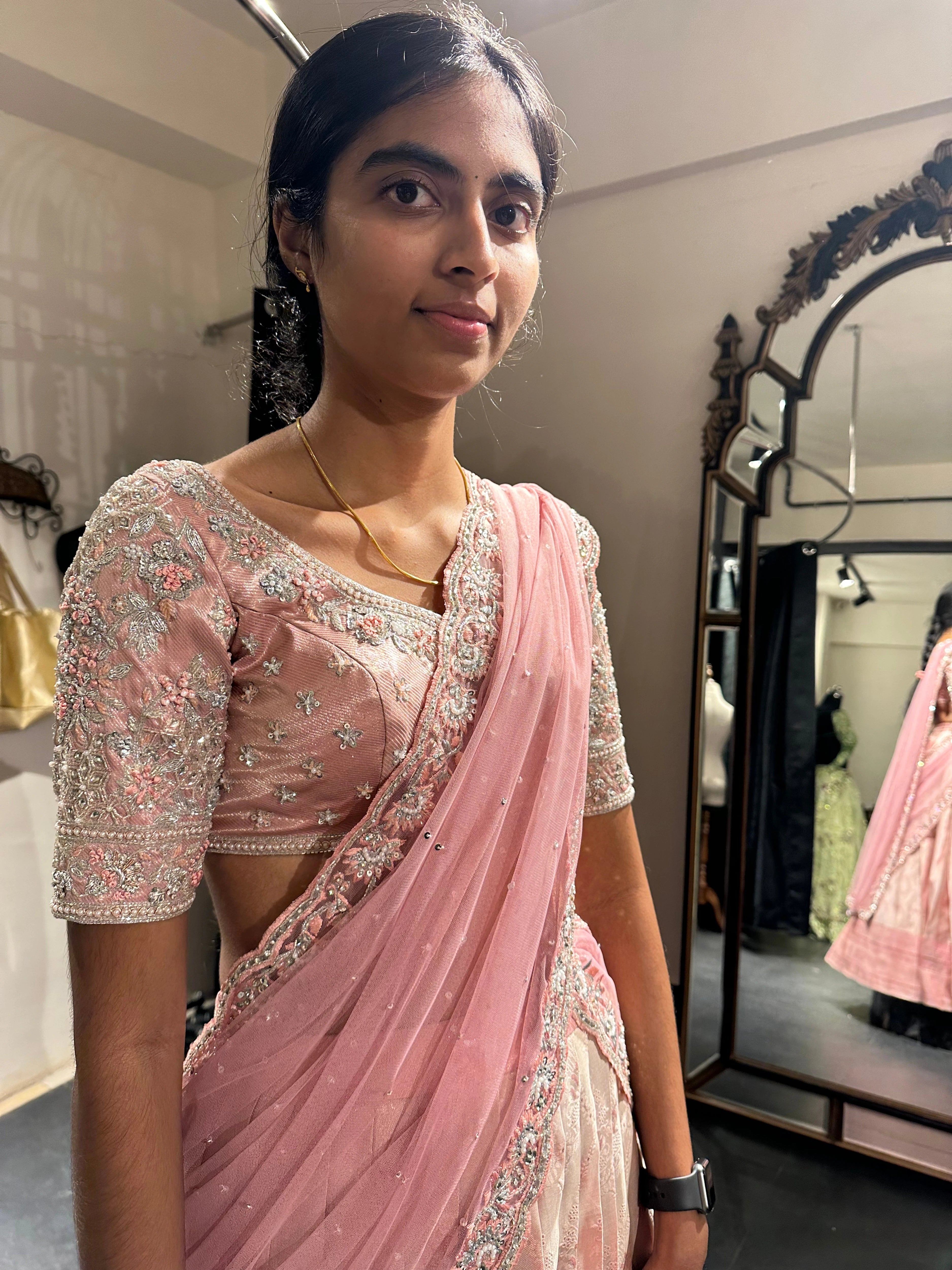 Bridesmaid during her fittings in an onion pink half saree, handcrafted by team Archana Karthick.