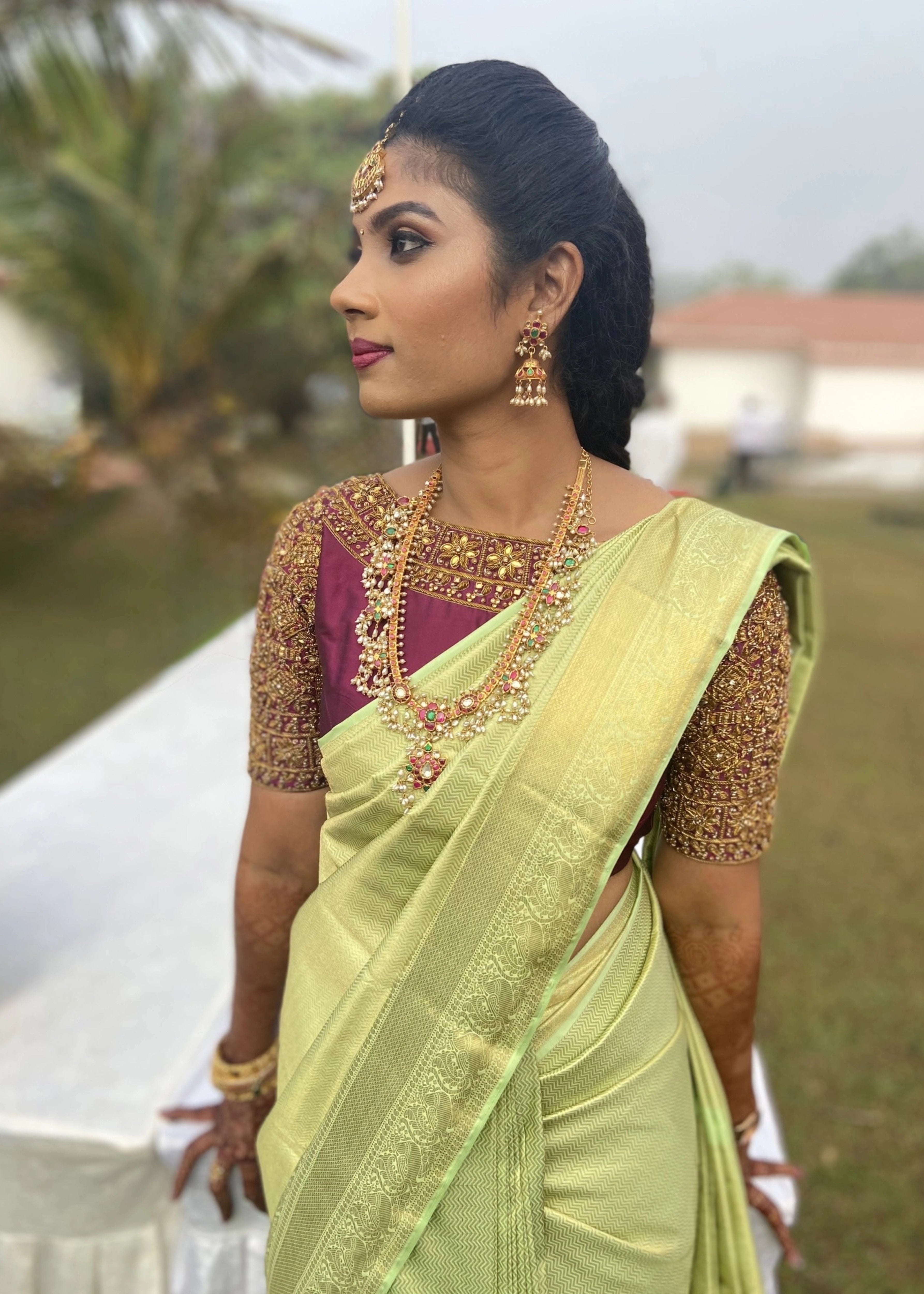Bridesmaid from Chennai for a closeup shot in a wine red silk blouse handcrafted intricately with zardozi and kemp stones designed by Archana Karthick.