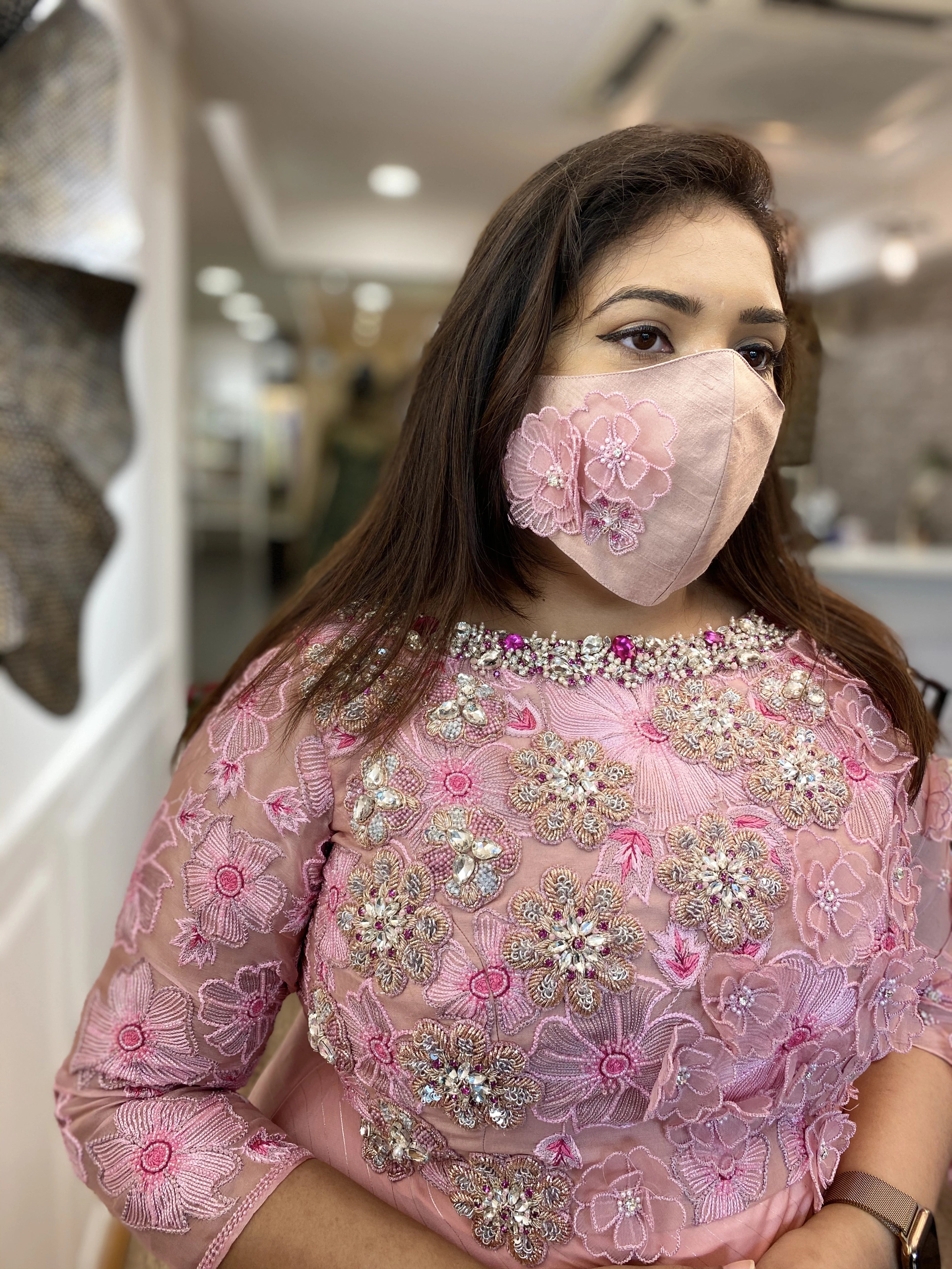 Bridesmaid from Chennai for her fittings in a pink organza gown and mask handcrafted intricately with zardozi, stones, pearls and 3D floral appliques designed by Archana Karthick.