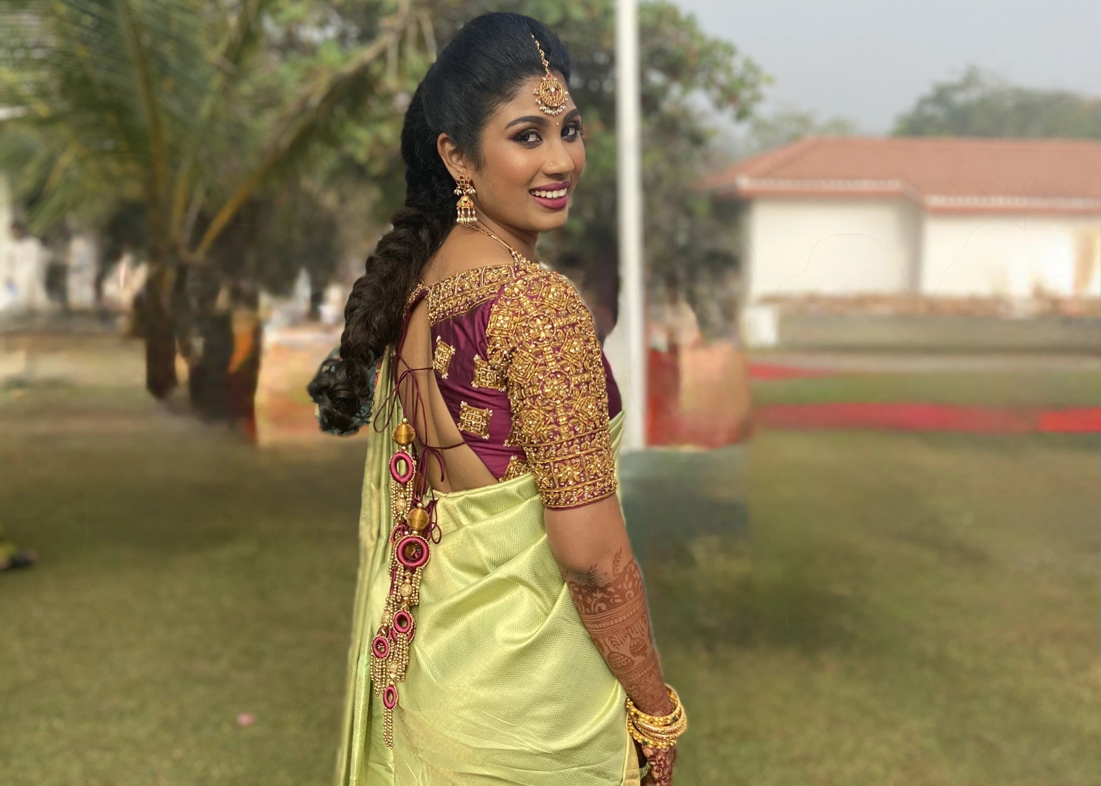 Bridesmaid from Chennai in a wine red silk blouse handcrafted intricately with zardozi and kemp stones designed by Archana Karthick.