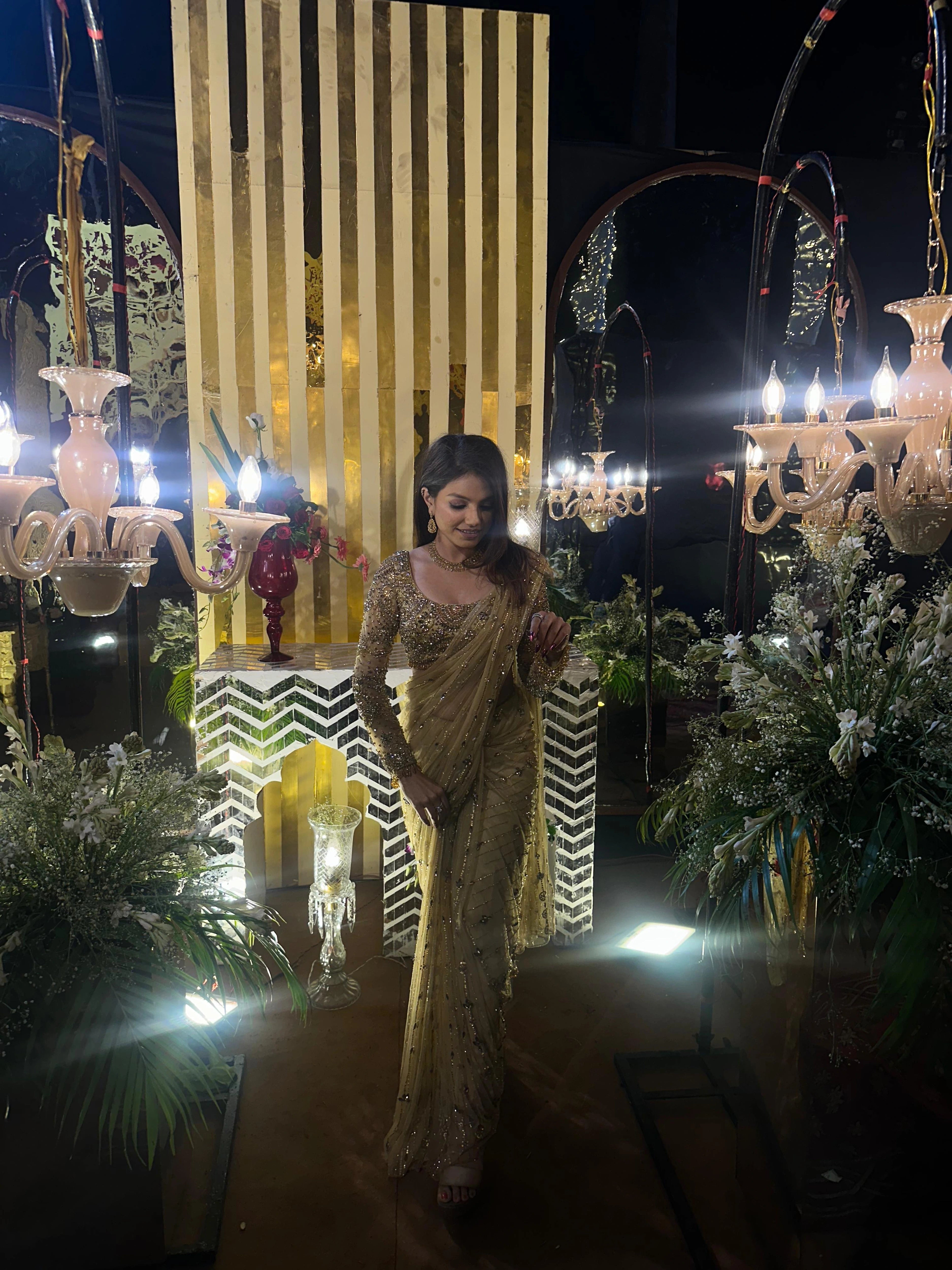 Bridesmaid Vidushi from Jamshedpur, posing in a golden tulle saree handcrafted by team Archana Karthick.