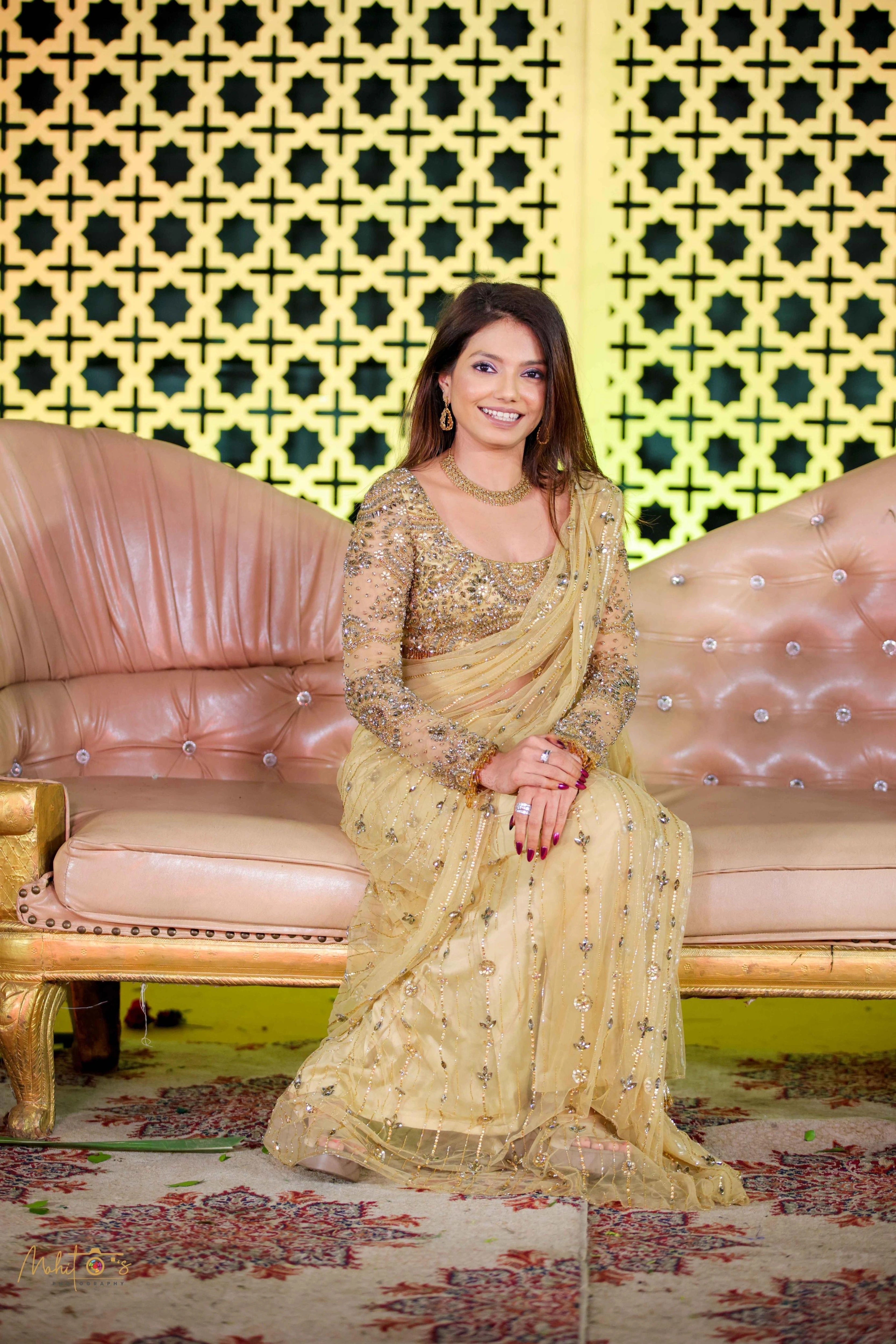 Bridesmaid Vidushi from Jamshedpur, seated in a golden tulle saree handcrafted by team Archana Karthick.