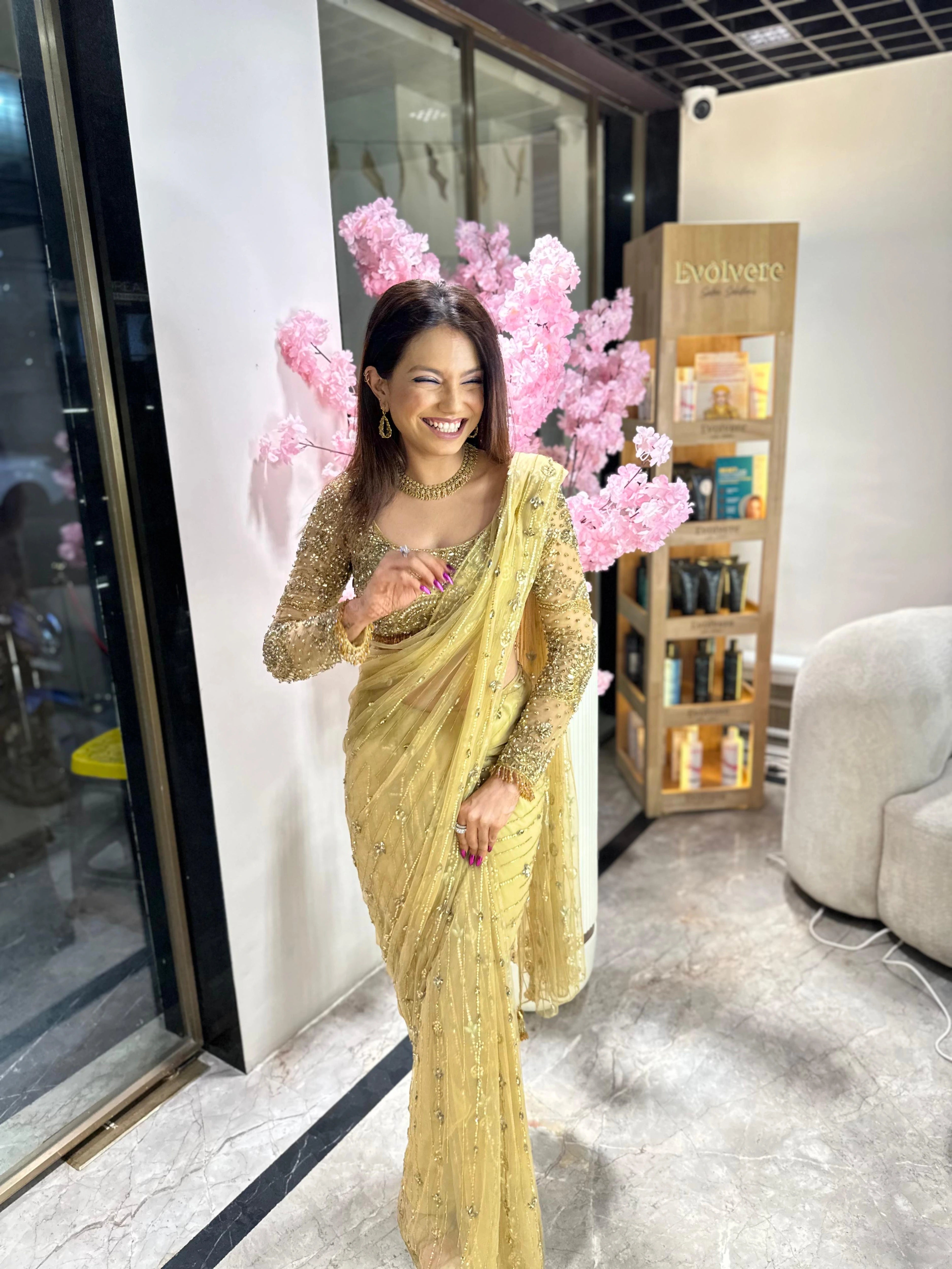 Bridesmaid Vidushi from Jamshedpur, smiling in a golden tulle saree handcrafted by team Archana Karthick.