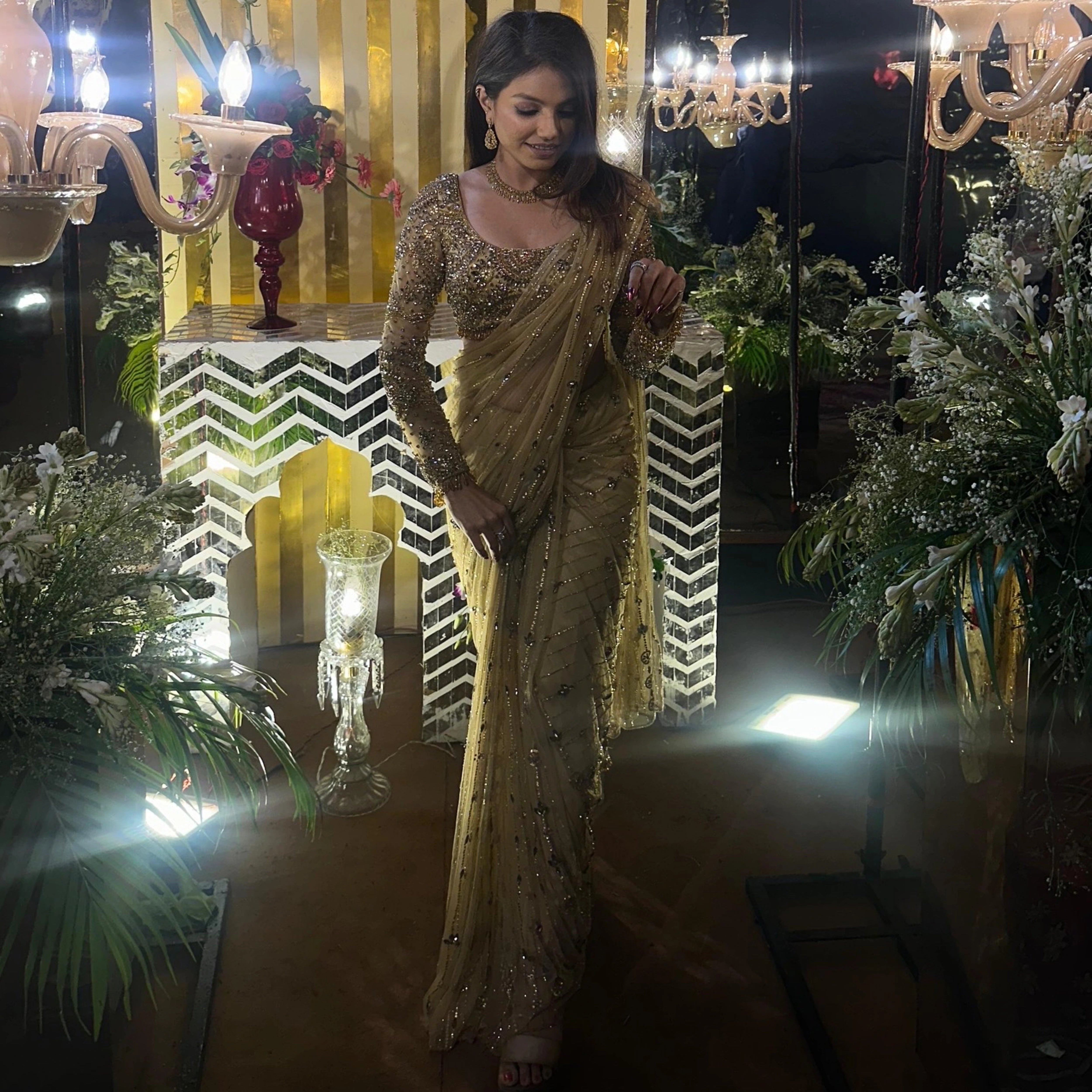 Bridesmaid Vidushi from Jamshedpur strikes a pose in a golden tulle saree handcrafted by team Archana Karthick.