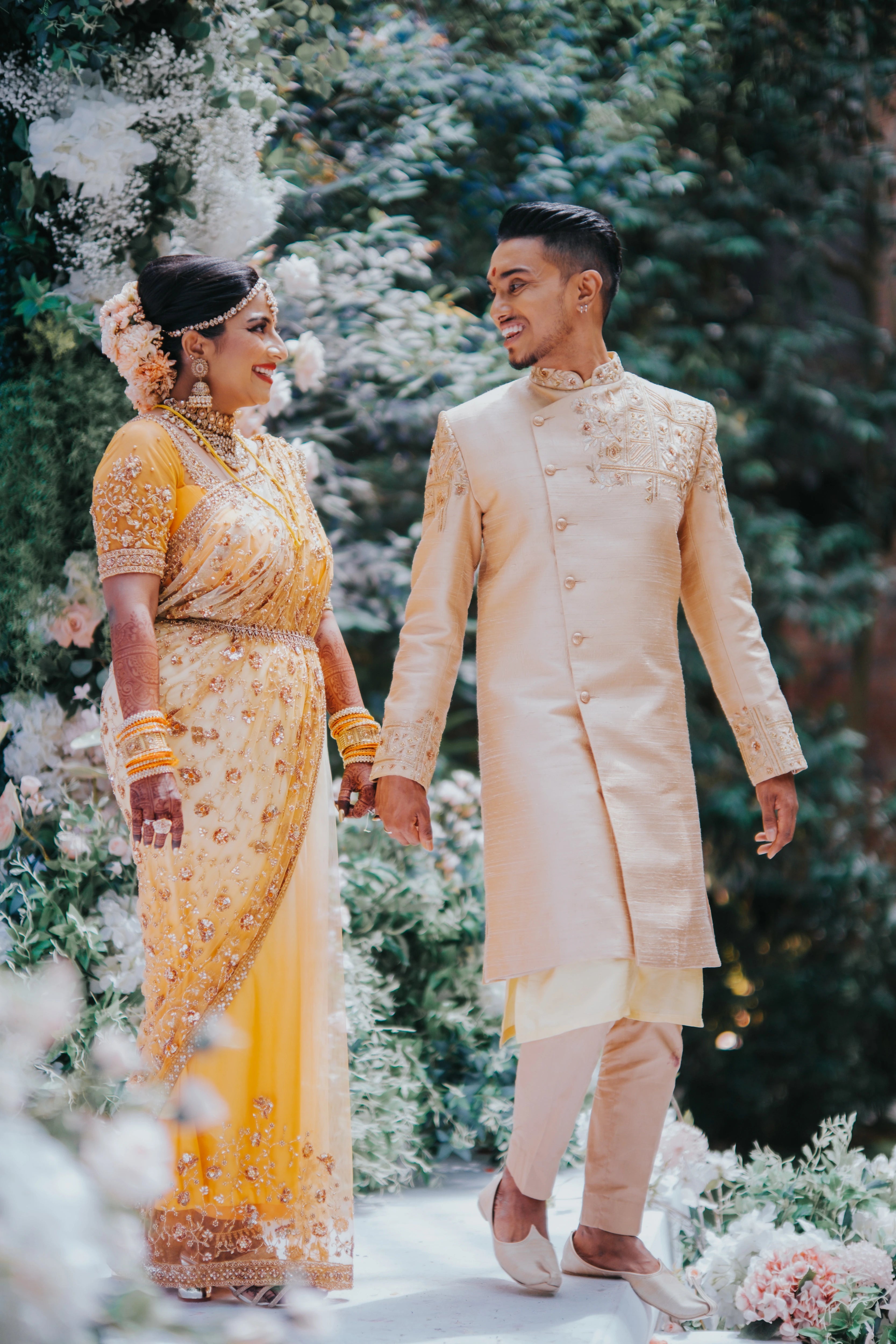 Couple from Malaysia posing in a sherwani handcrafted by team Archana Karthick.