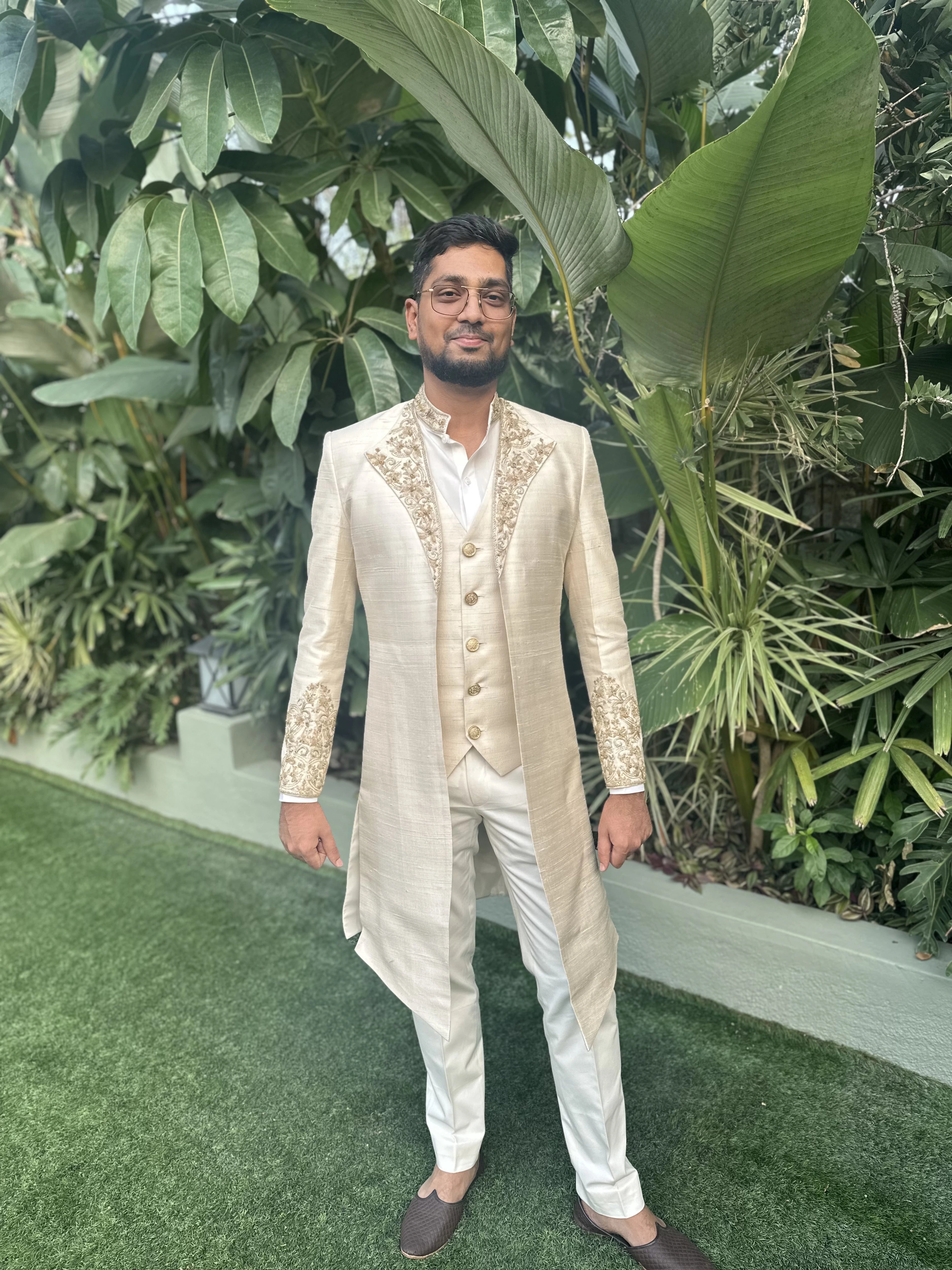 Groom Mahesh from bangalore in an ivory raw silk sherwani handcrafted by team Archana Karthick.