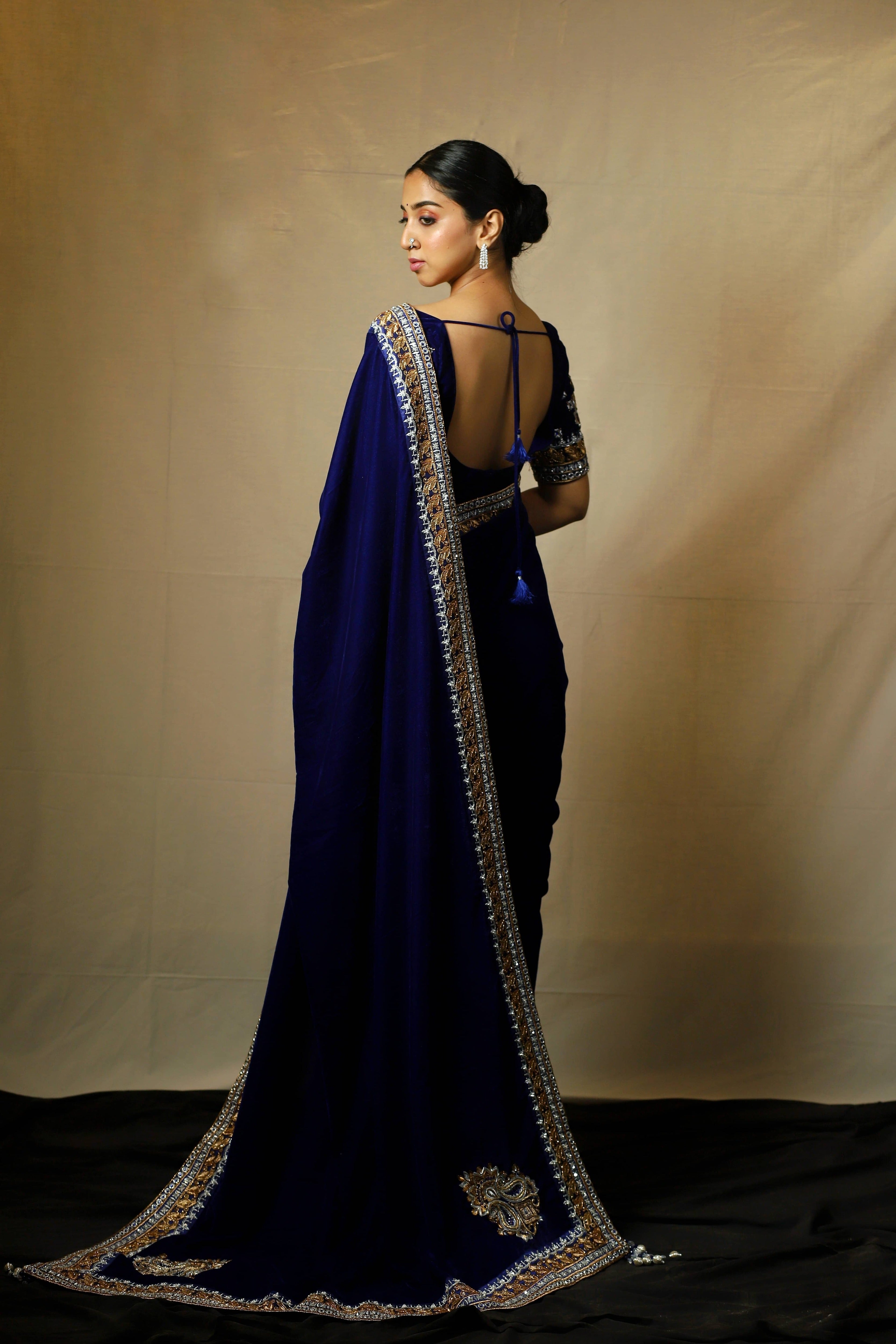 Influencer Deekshita Nikkam in a navy velvet saree and blouse set with zardozi detailings on border and sleeves. Full back and pallu flare