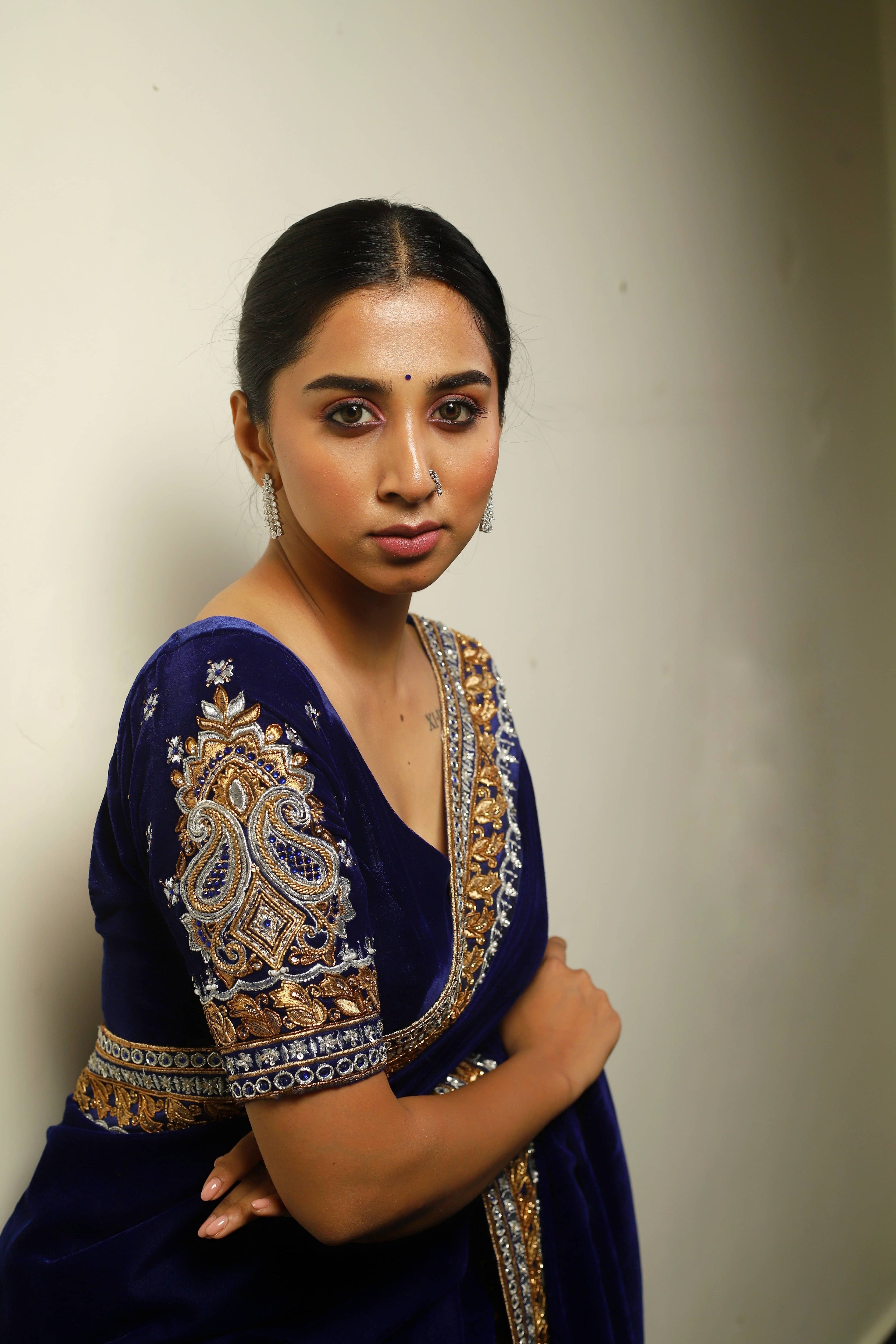 Influencer Deekshita Nikkam in a navy velvet saree and blouse set with zardozi detailings on border and sleeves. sleeve and neckline