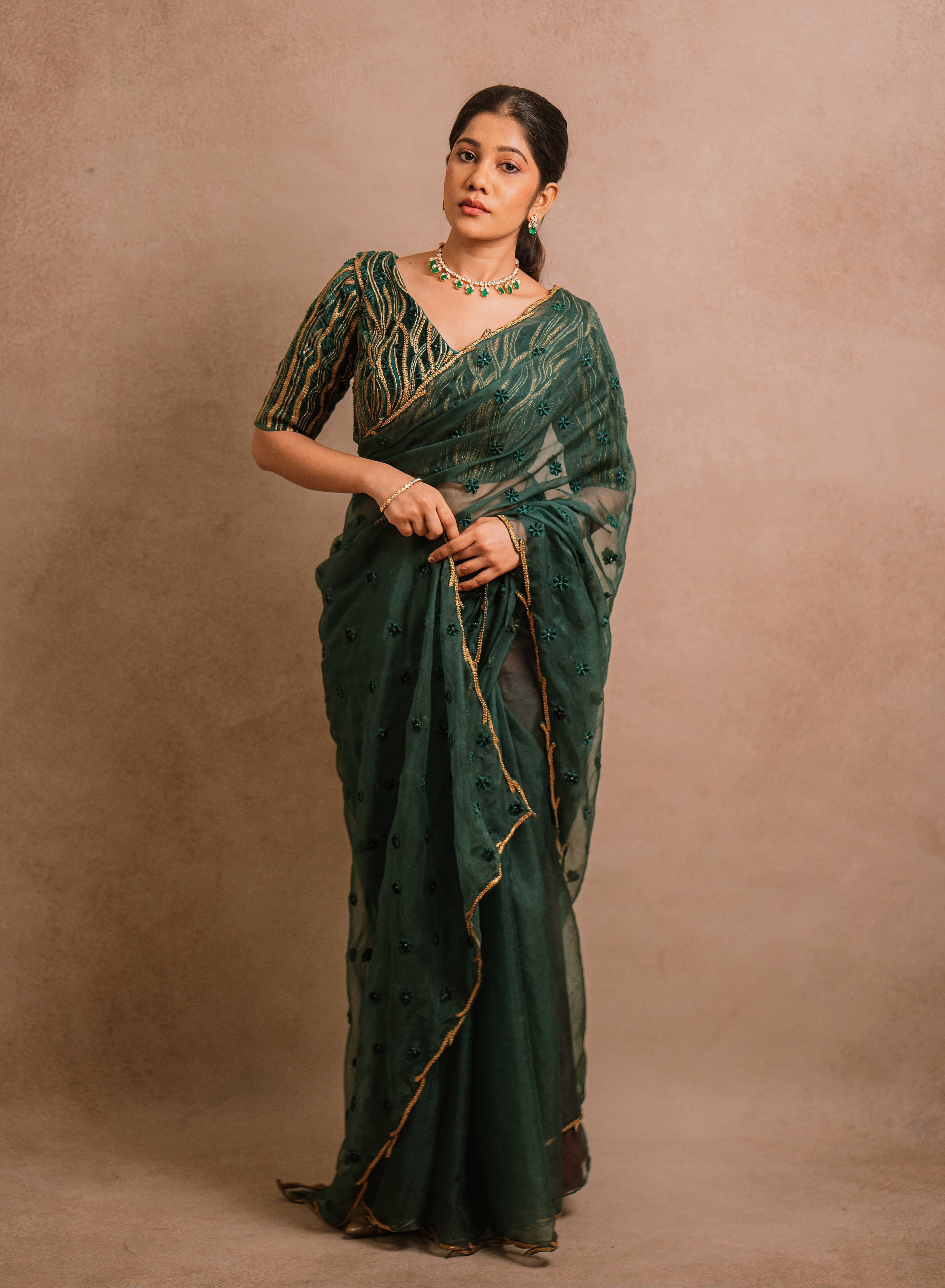 Jaina Parmar, known for recreating looks of actress Nayanthara is seen here in green organza saree set designed by Archana Karthick posing straight at camera