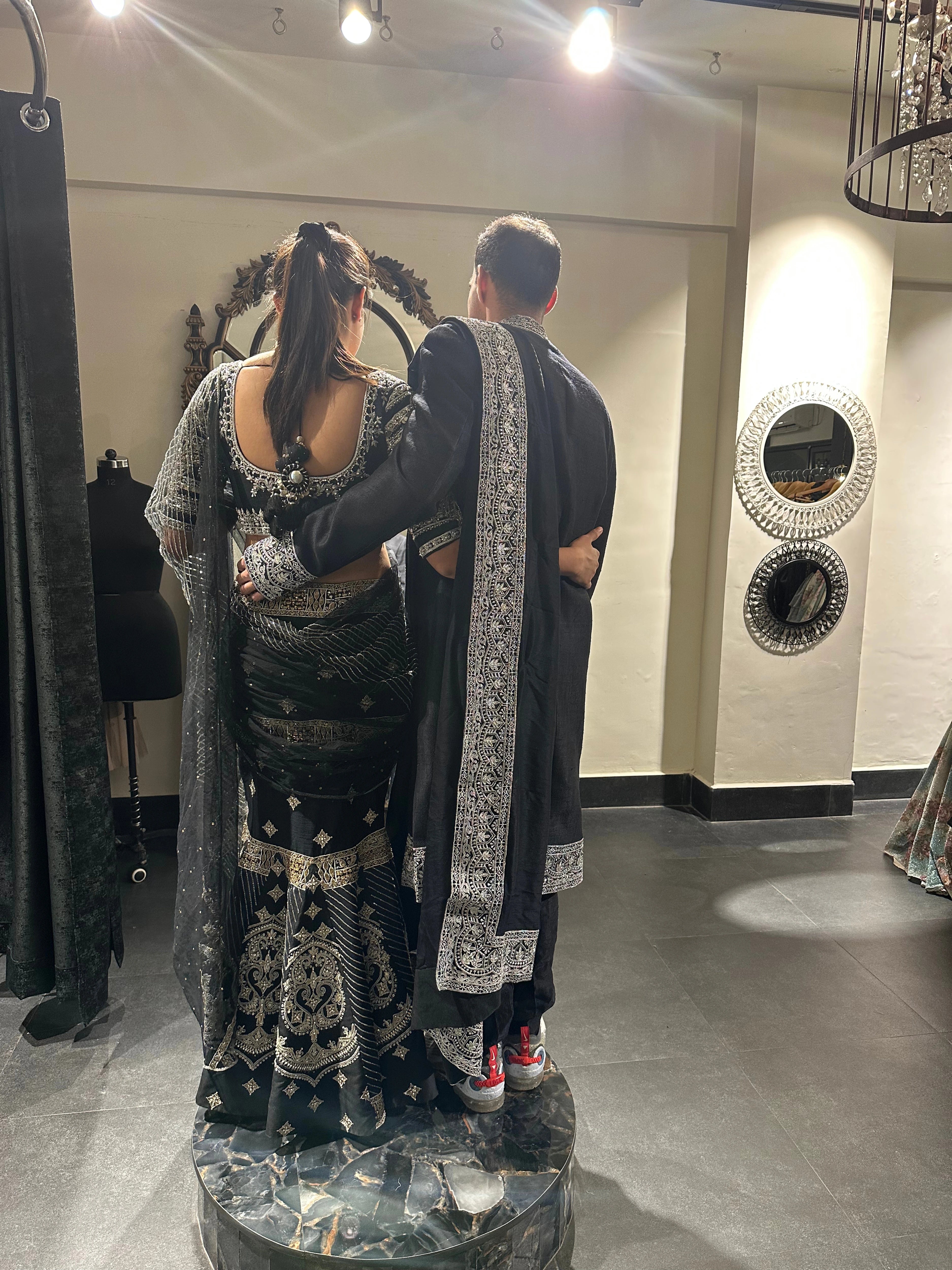 Kamakshi & Alex from Yokosuka, Japan, during fittings in a black raw silk lehenga and sherwani handcrafted by team Archana Karthick.