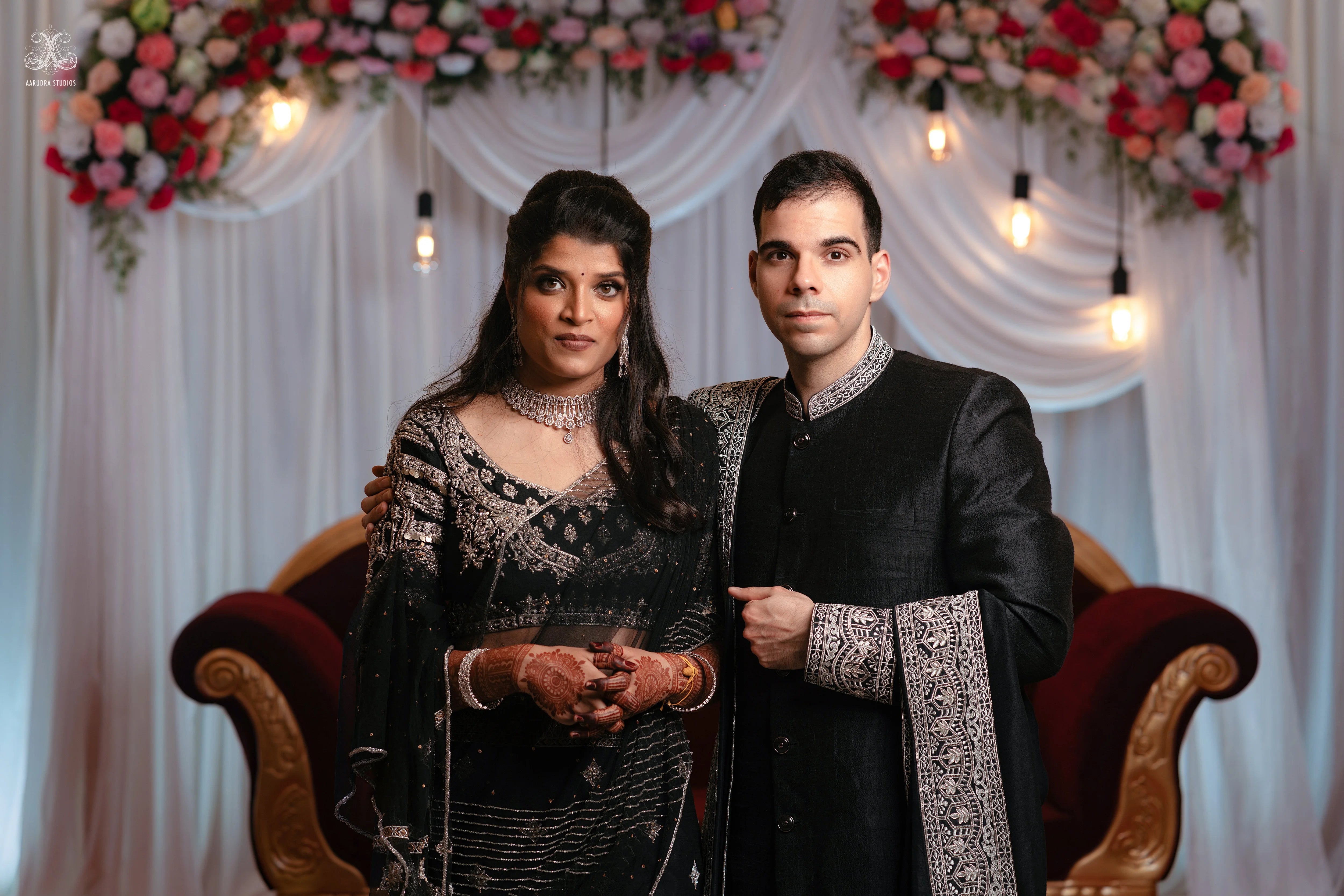 Kamakshi & Alex from Yokosuka, Japan, in a black raw silk lehenga and sherwani handcrafted by team Archana Karthick.