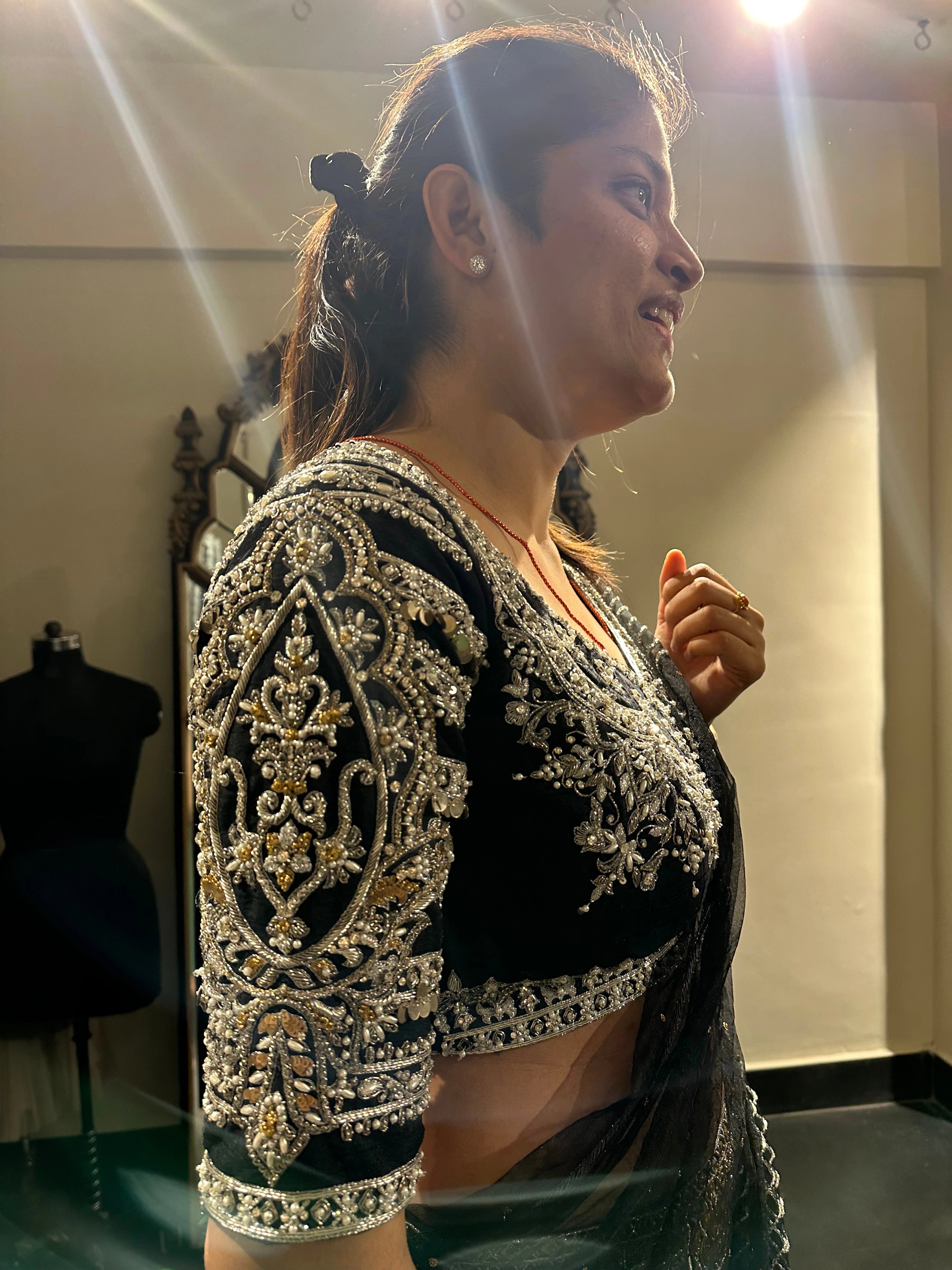 Kamakshi from Yokosuka, Japan, during fittings in a black raw silk lehenga handcrafted by team Archana Karthick.