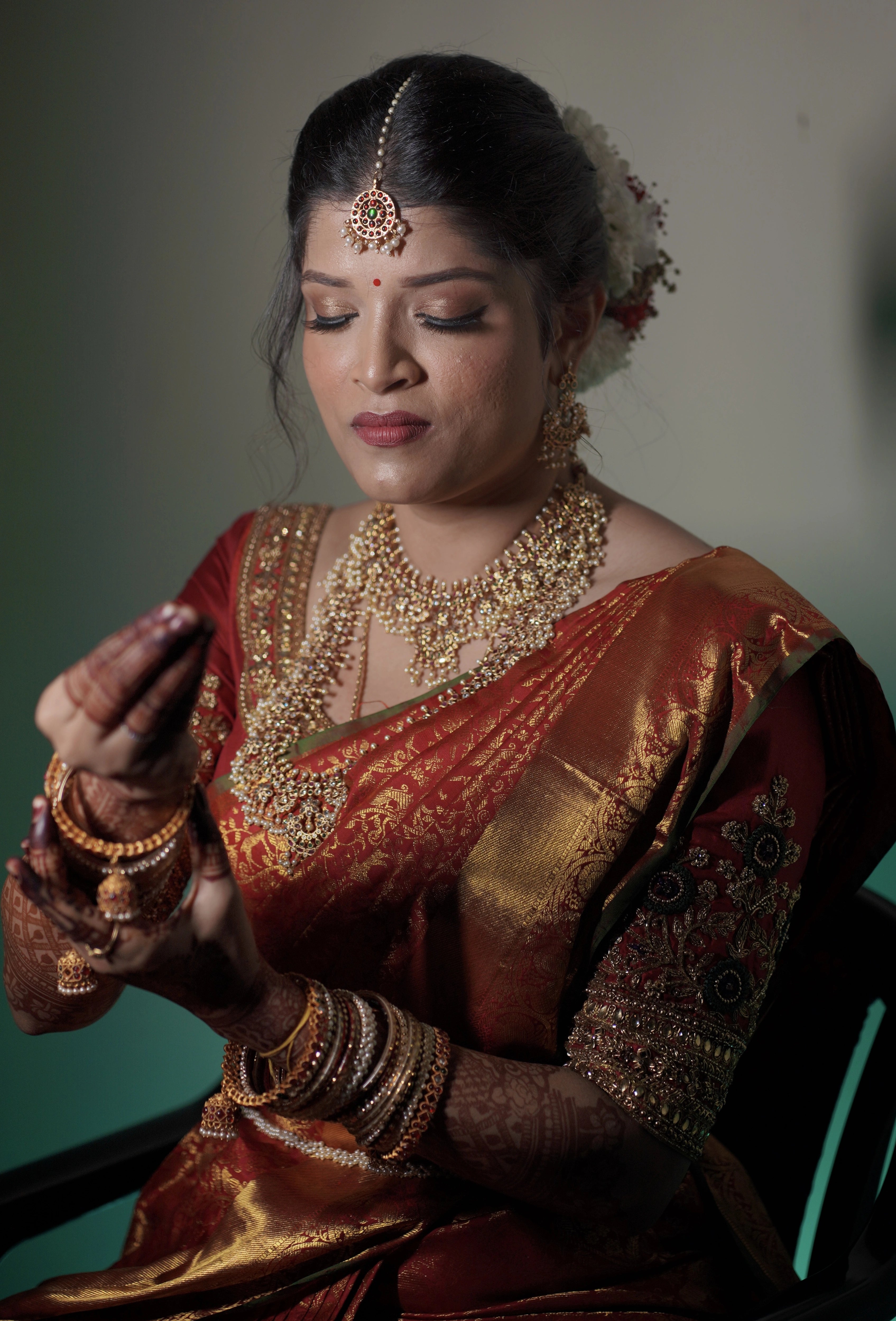 Kamakshi from Yokosuka, Japan in a red silk blouse handcrafted by team Archana Karthick.