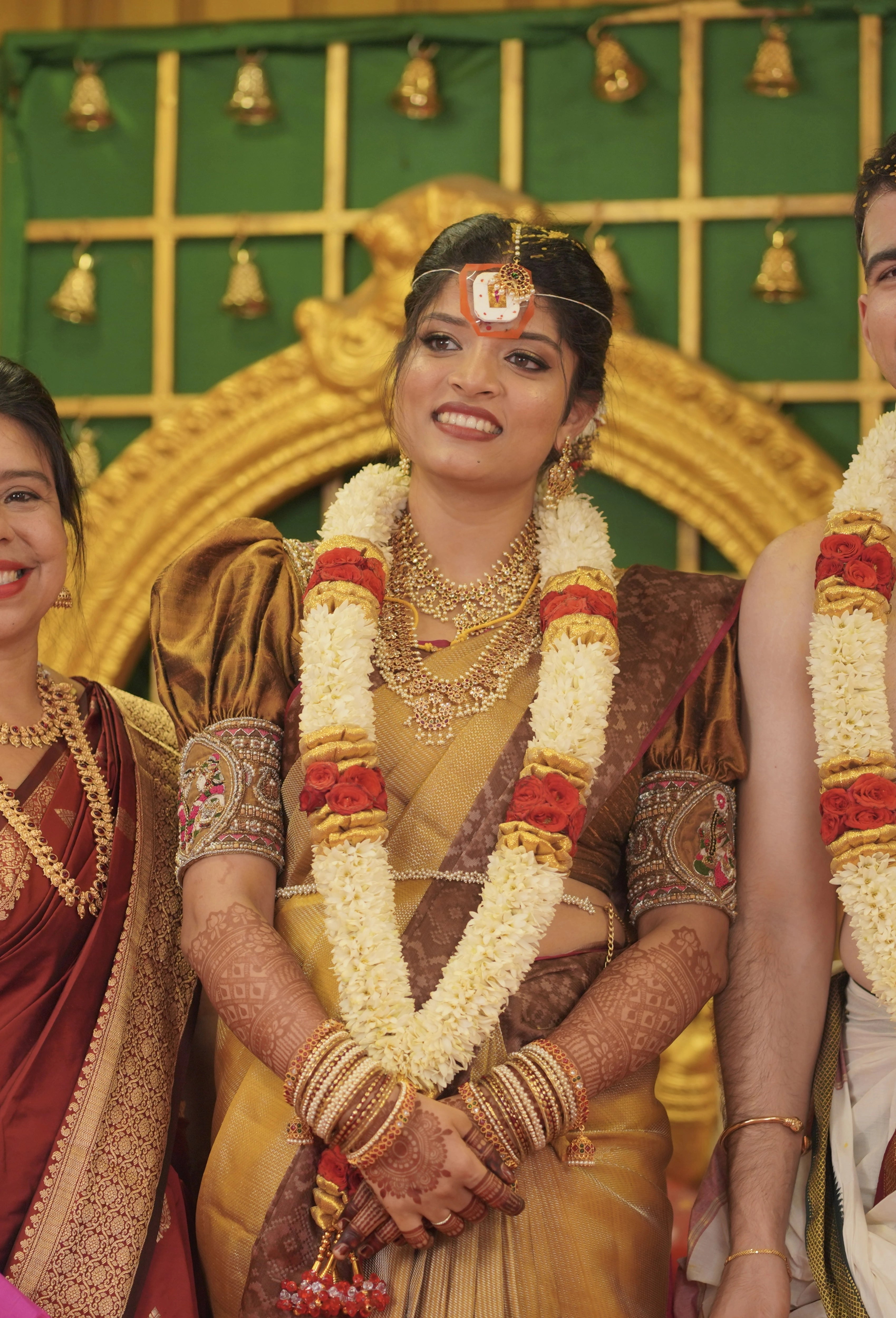 Kamakshi from Yokosuka, Japan, posing on stage in a mustard silk blouse handcrafted by team Archana Karthick.