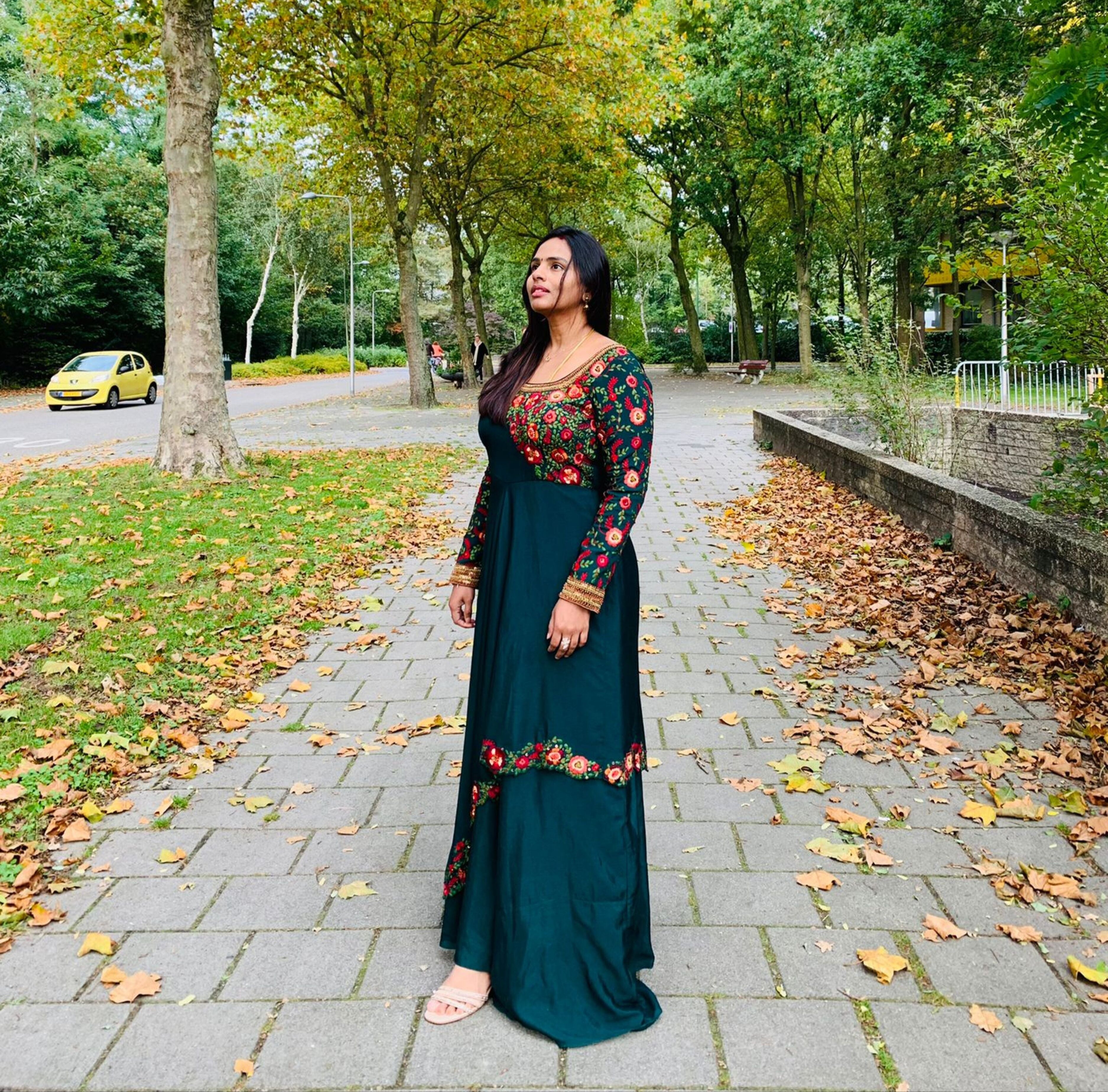 Kowsalya fro Buffalo, USA in an a green multi-layered anarkali designed by Archana Karthick. Straight at the camera full side profile.